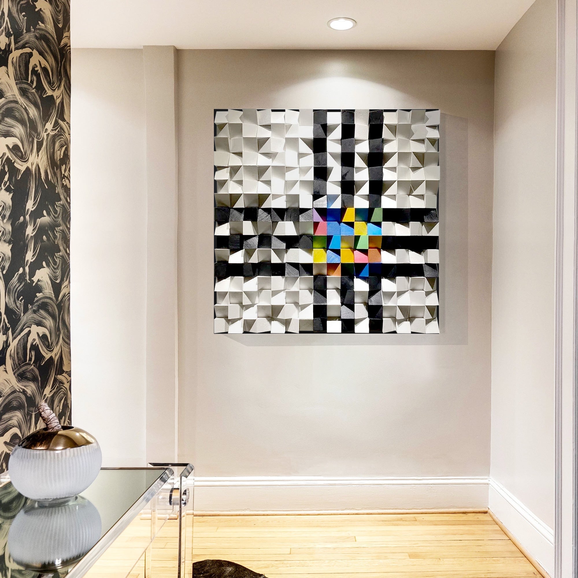 Three-dimensional geometric wood artwork with a symmetrical grid arrangement, blending monochrome tones and colorful accents at hallway.