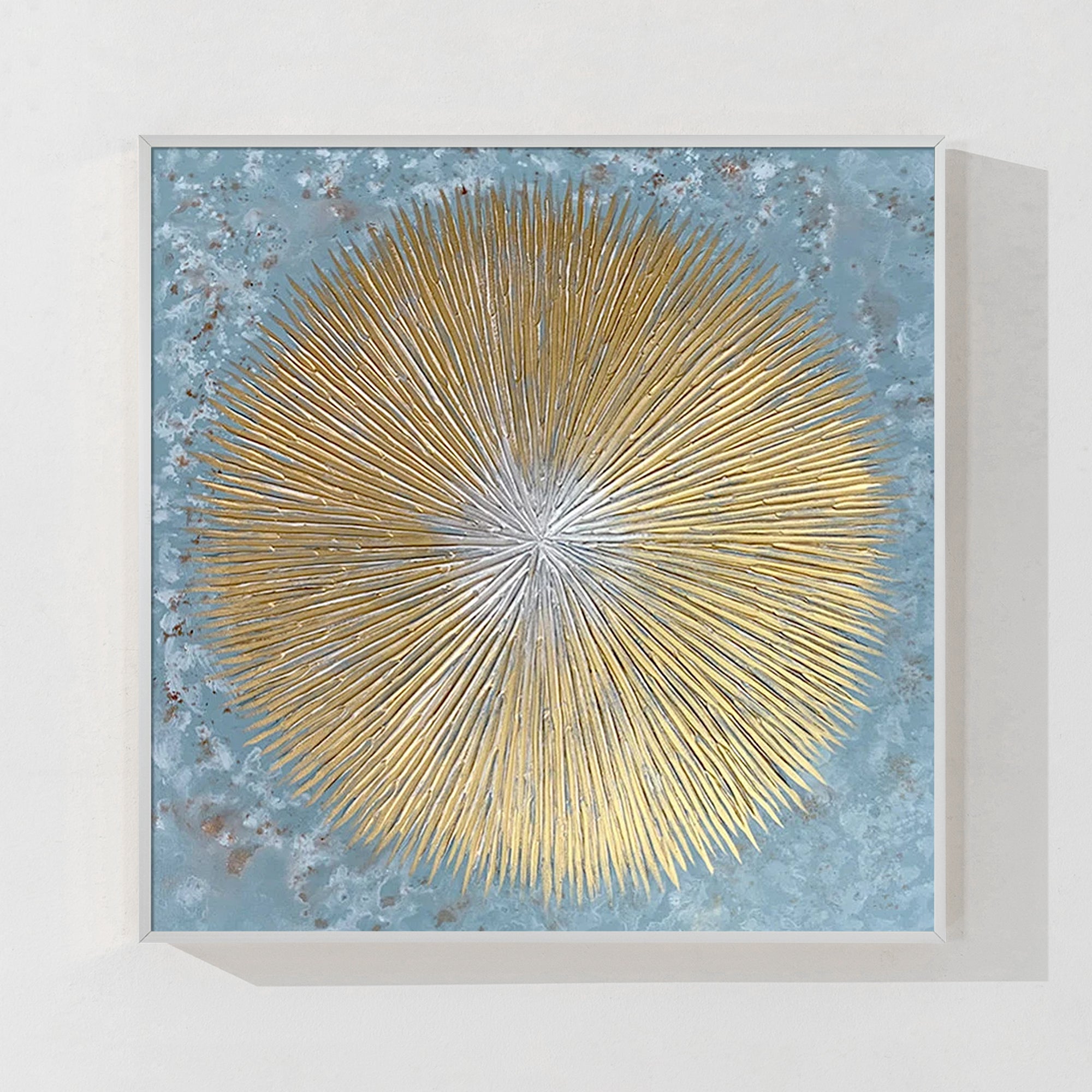 Abstract large wall art with intricate gold circular forms in a white frame.