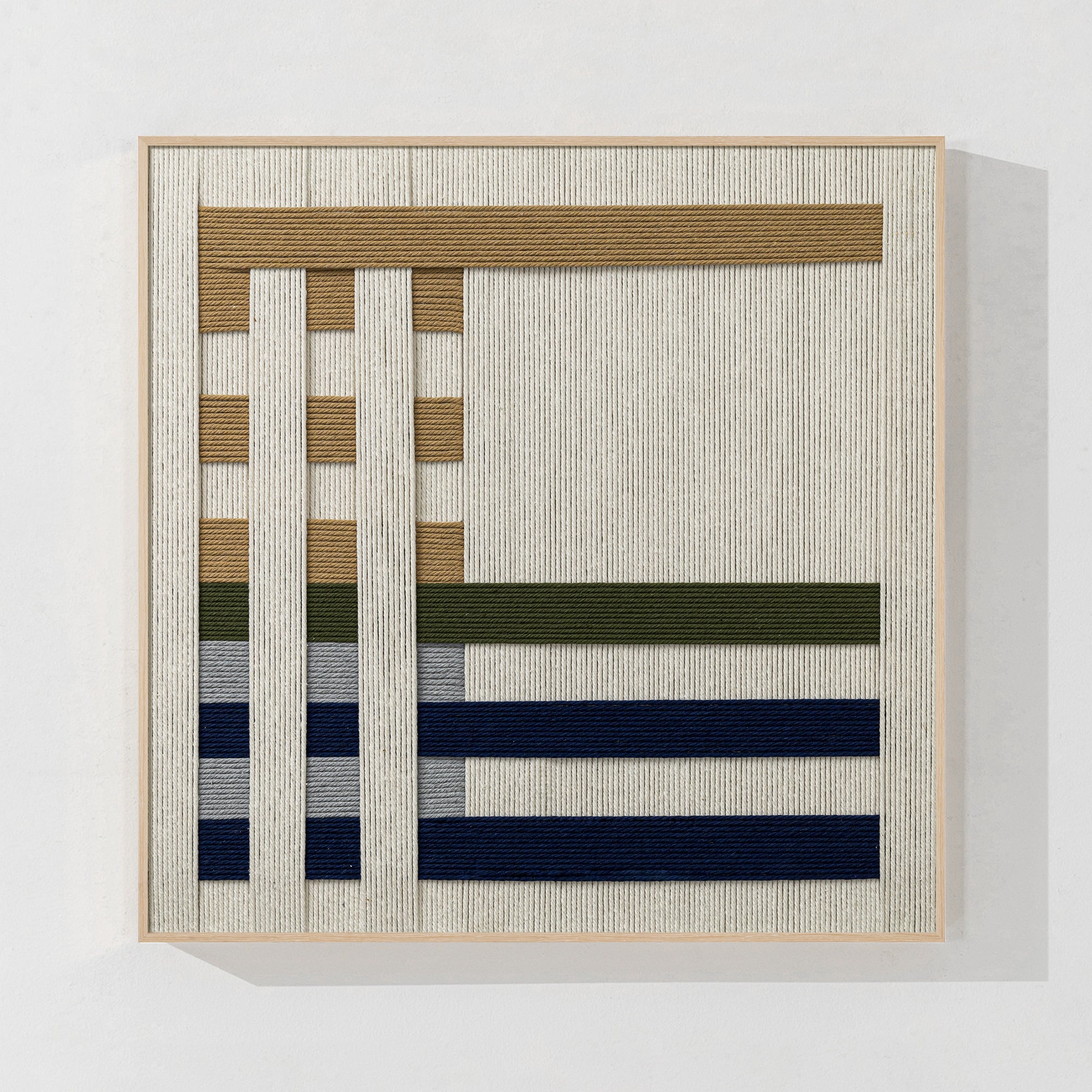 Minimalist yarn wall hanging in layered design, ideal for Scandinavian-inspired interiors.