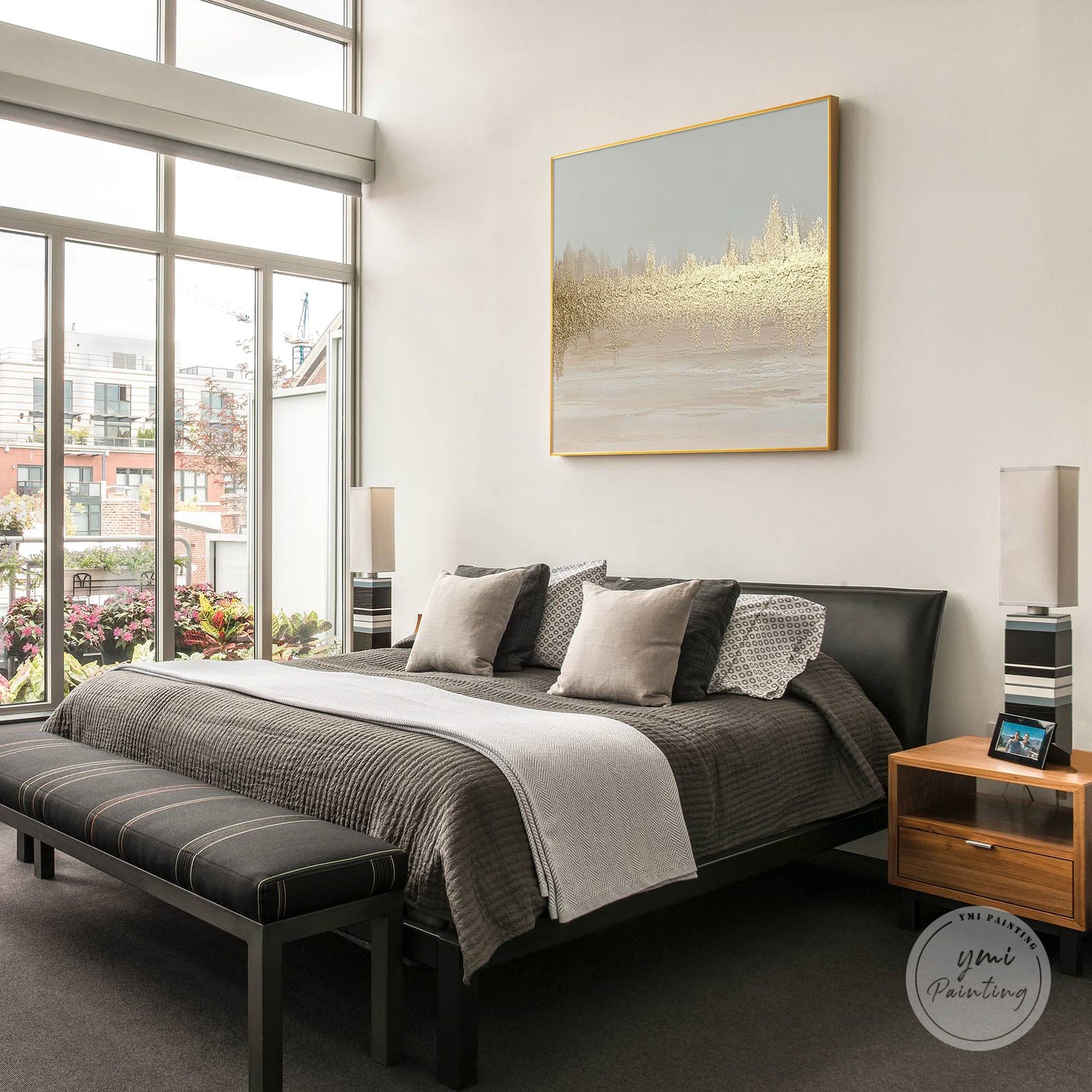 Hand painted abstract gold wall art with layered texture presented in a calm bedroom setting.