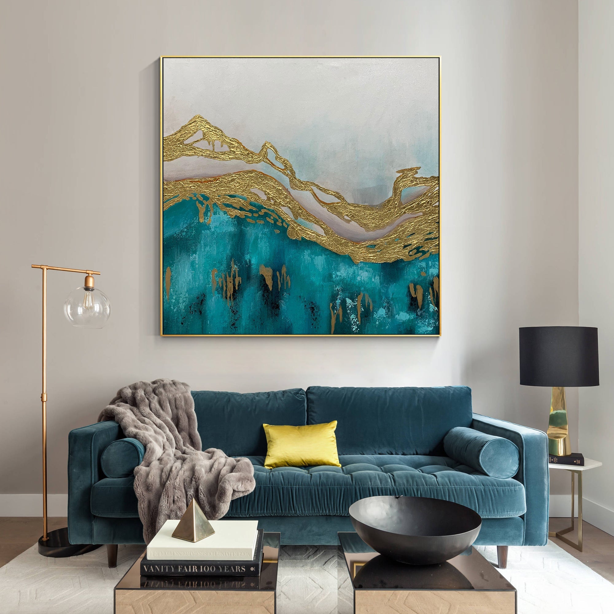 Abstract turquoise and gold mountain canvas creating a calm focal point in a living room