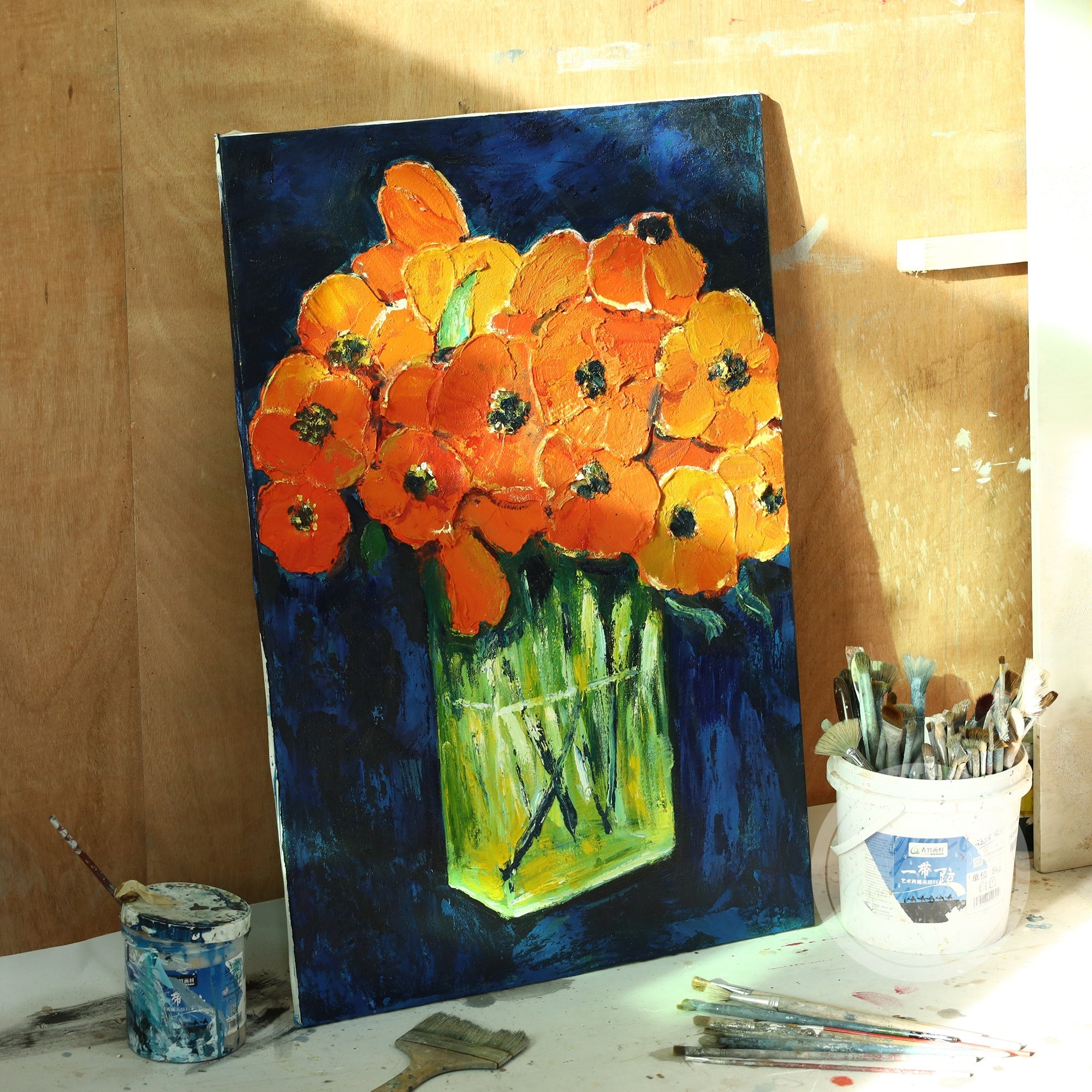 Add vibrancy to your modern decor with this abstract flower painting of orange blooms, featuring bold brushstrokes and contrasting cool blue tones.