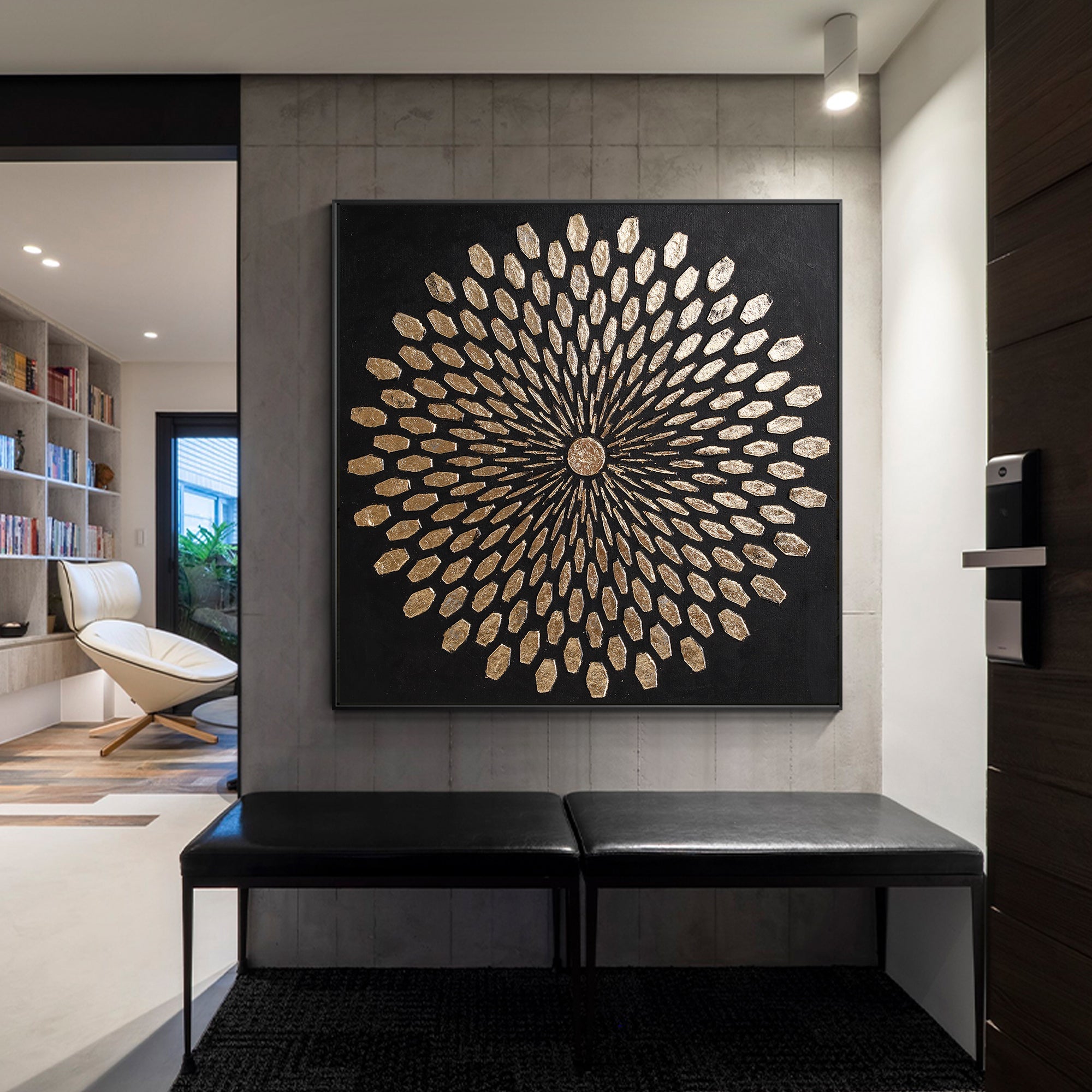 Abstract black and gold wall art displayed in a refined entryway