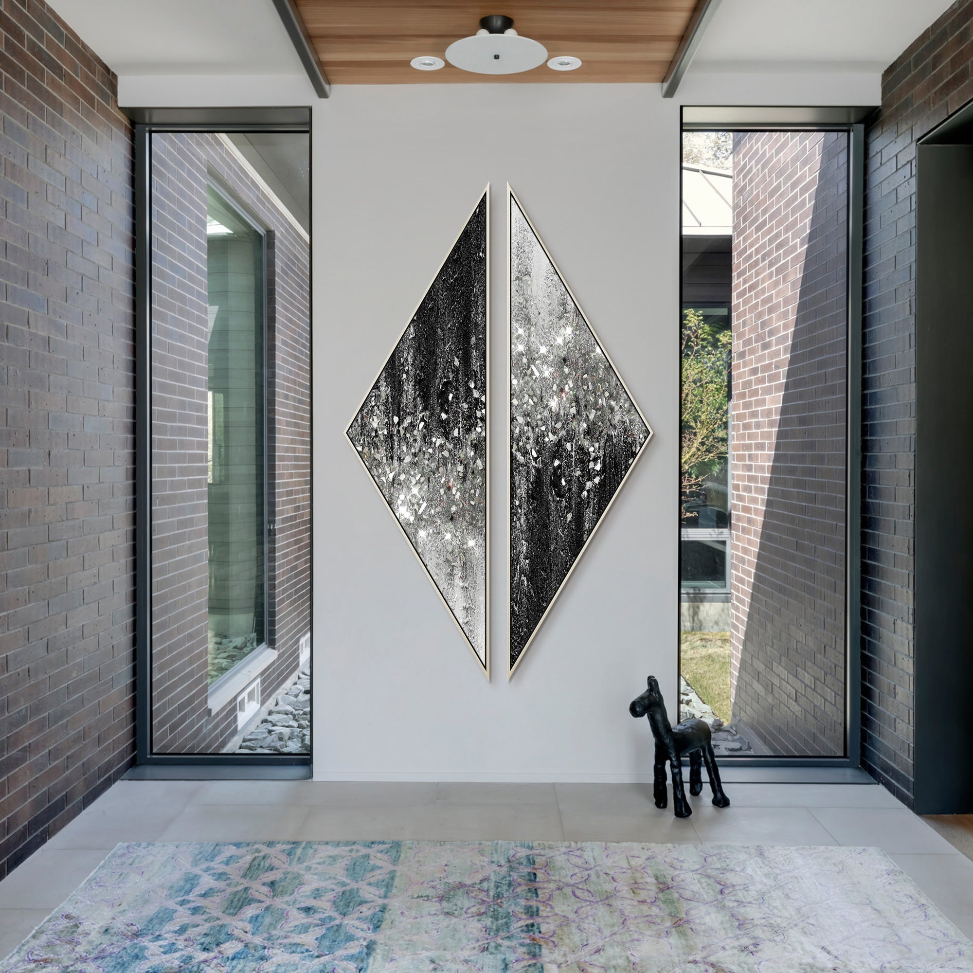 Contemporary abstract wall decor featuring triangular forms and silver glitter filtering between tones
