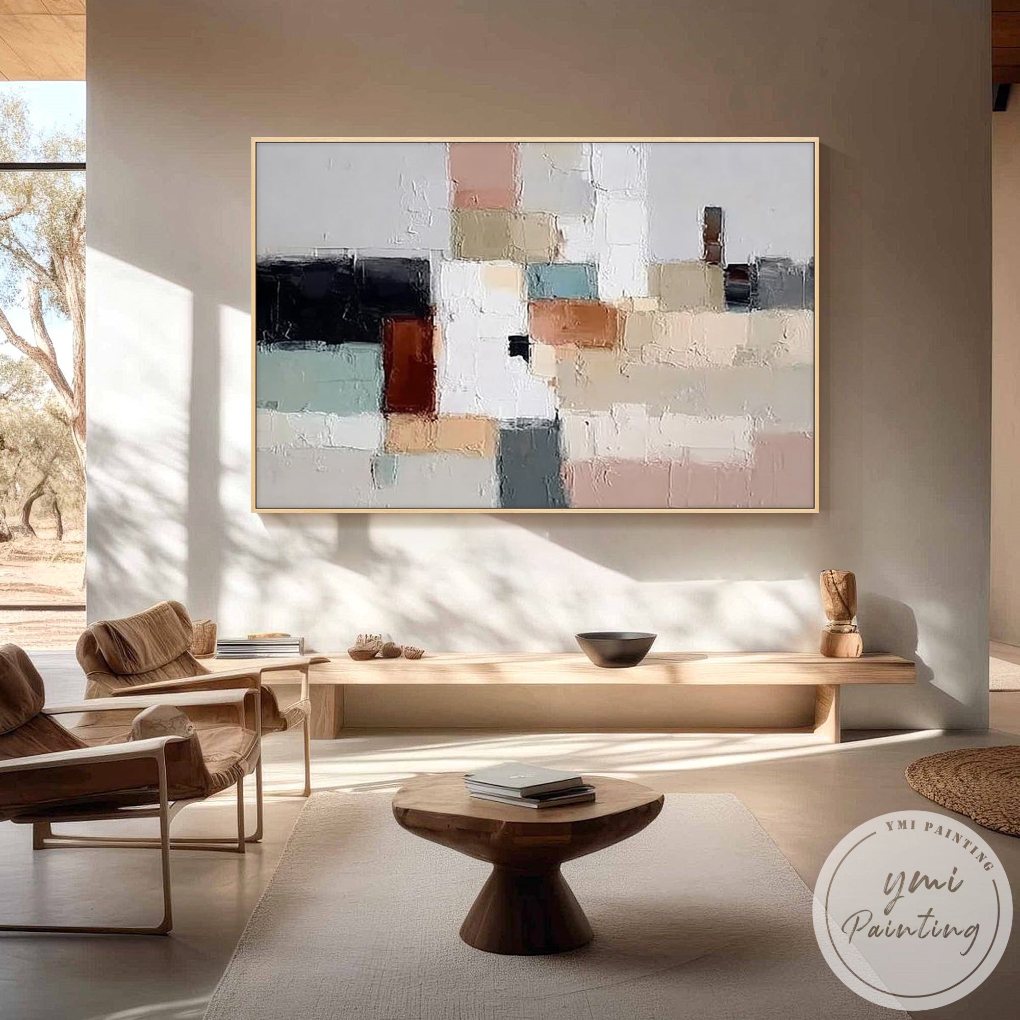 Neutral white and taupe canvas artwork displayed above wooden console table