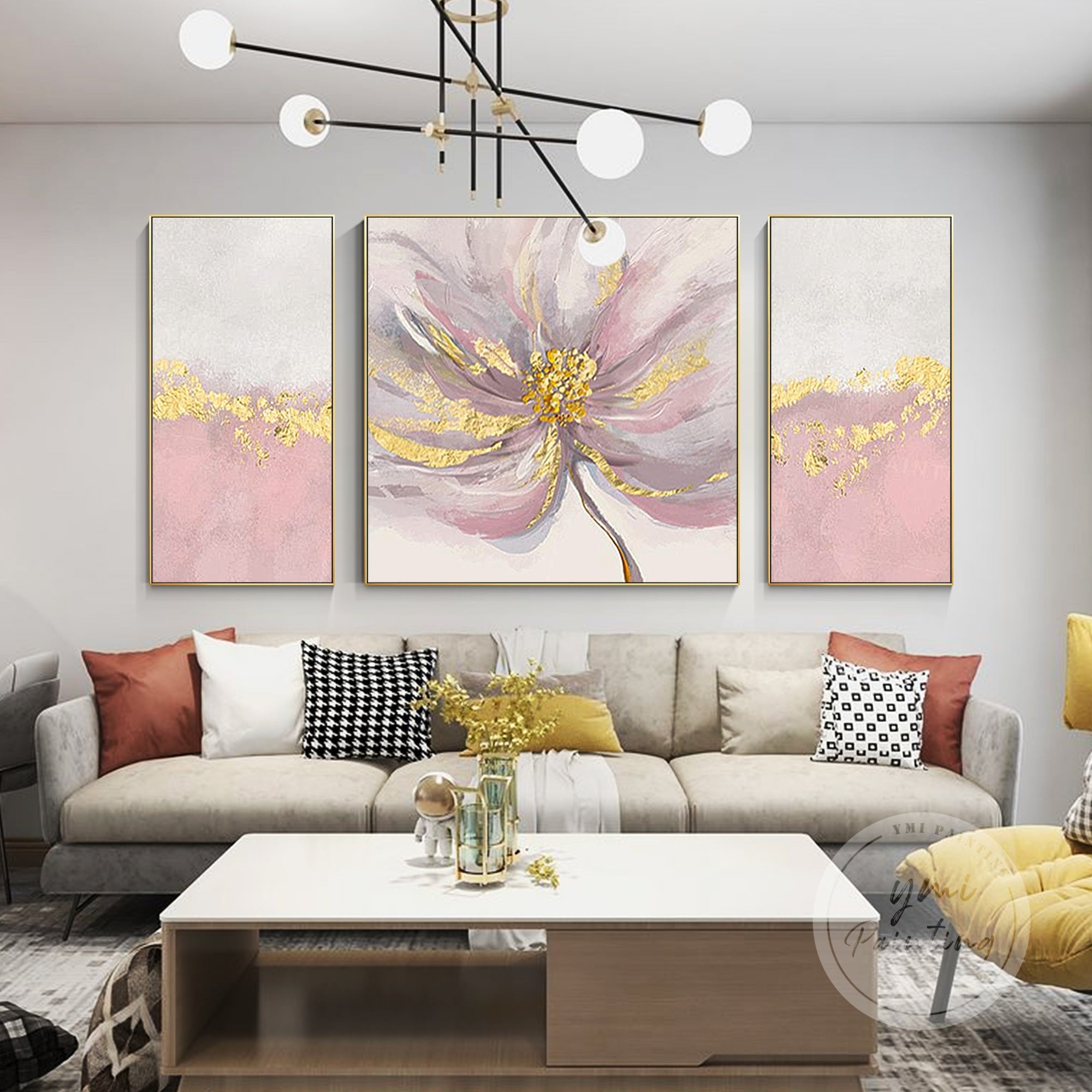 This abstract floral 3-piece wall art set blends pink, gray, and gold tones to add a cozy yet modern aesthetic to your living room.