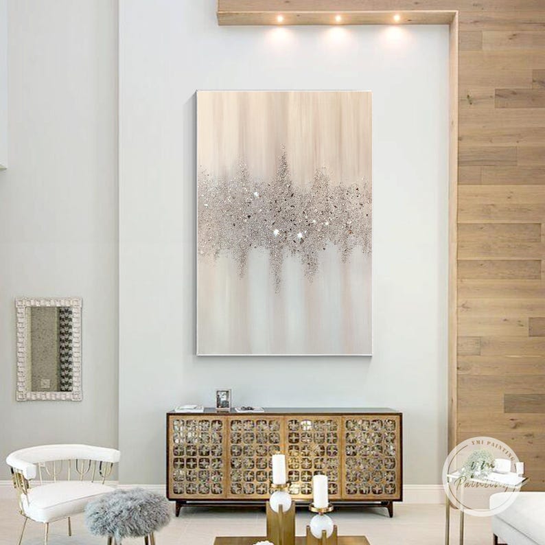 Abstract art with soft beige and pink tones, glitter, and glass