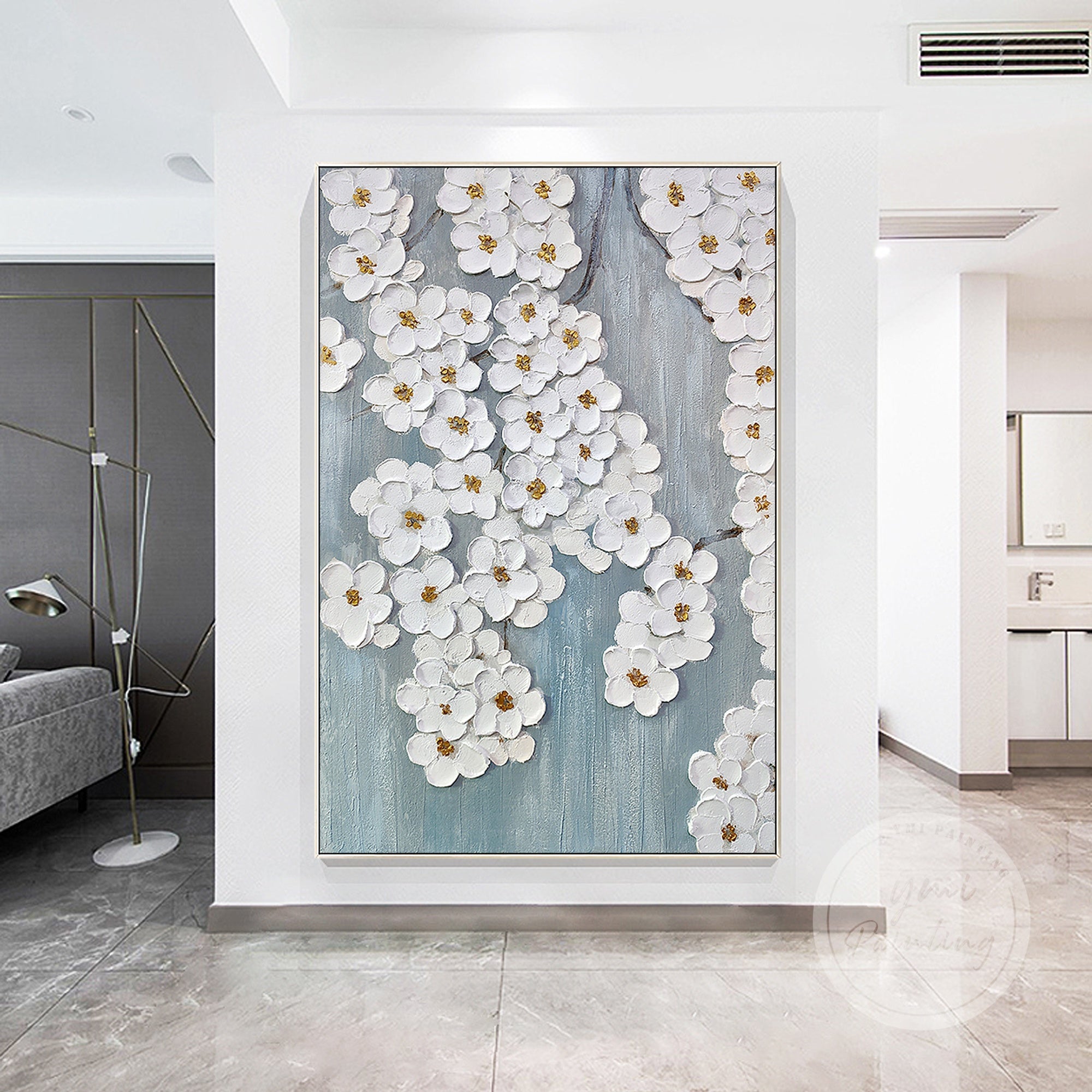 Add a touch of elegance to your living room with this serene flower blossom painting, featuring delicate white flowers and gold accents on a soft blue background.