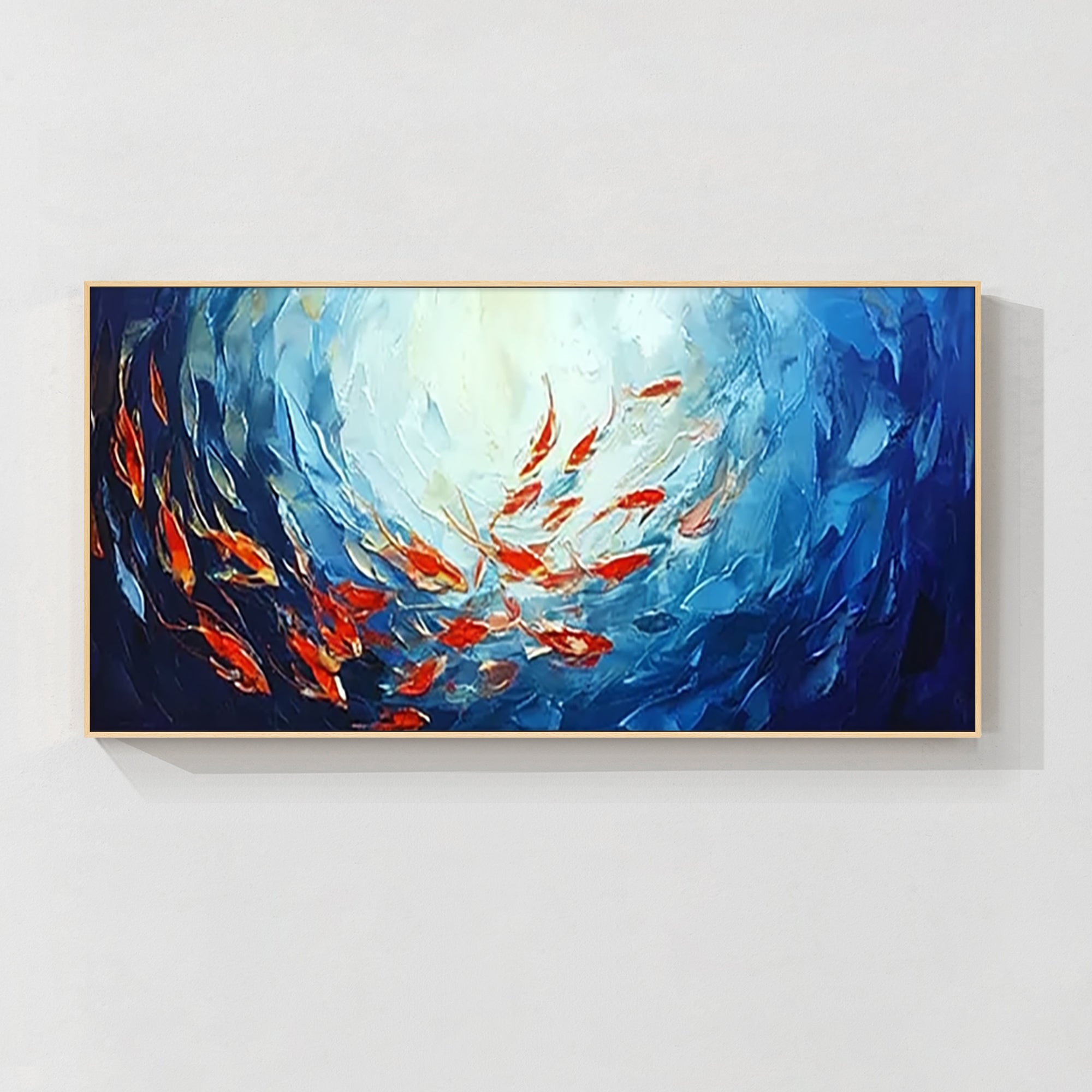 Navy ocean wall art featuring a vibrant red school of fish, hand-painted on canvas.