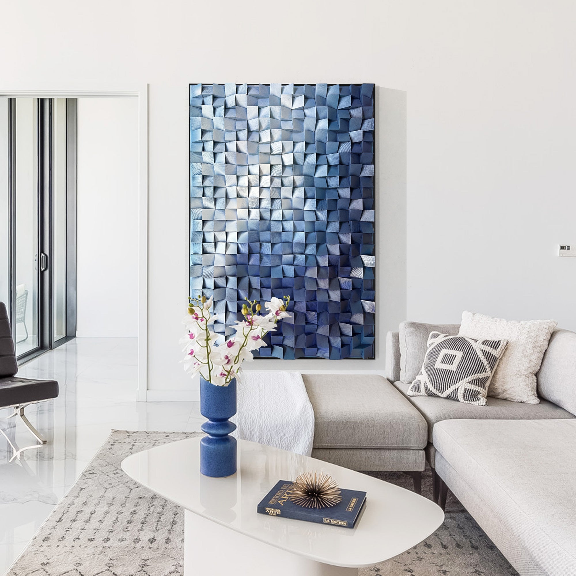 Modern cubist wall art with three-dimensional cubes in blue tones, arranged to form a gradient from light to dark in Mordern living room.