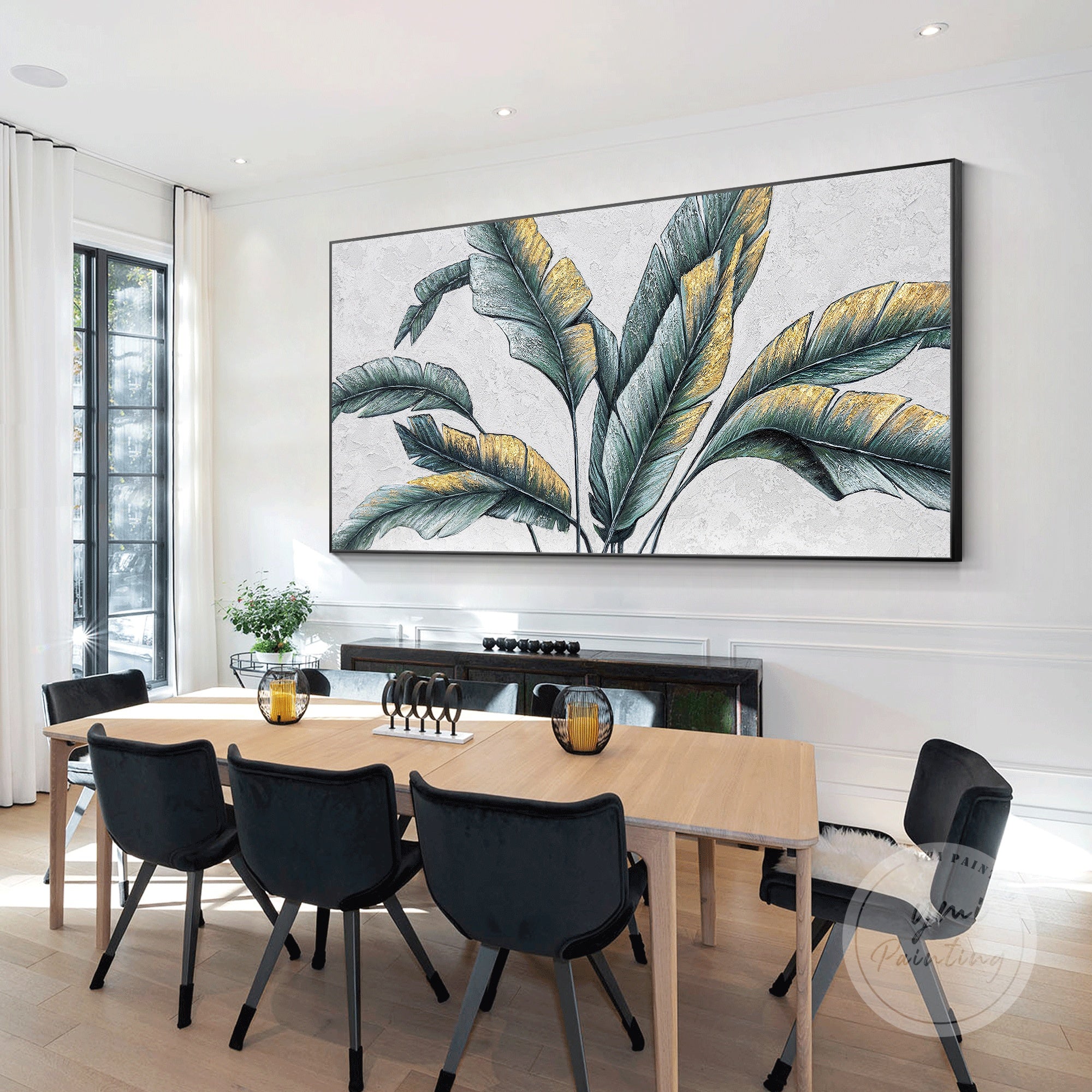 Framed botanical wall art featuring green banana leaves and gold leaf accents, perfect for adding a tropical touch to your home.