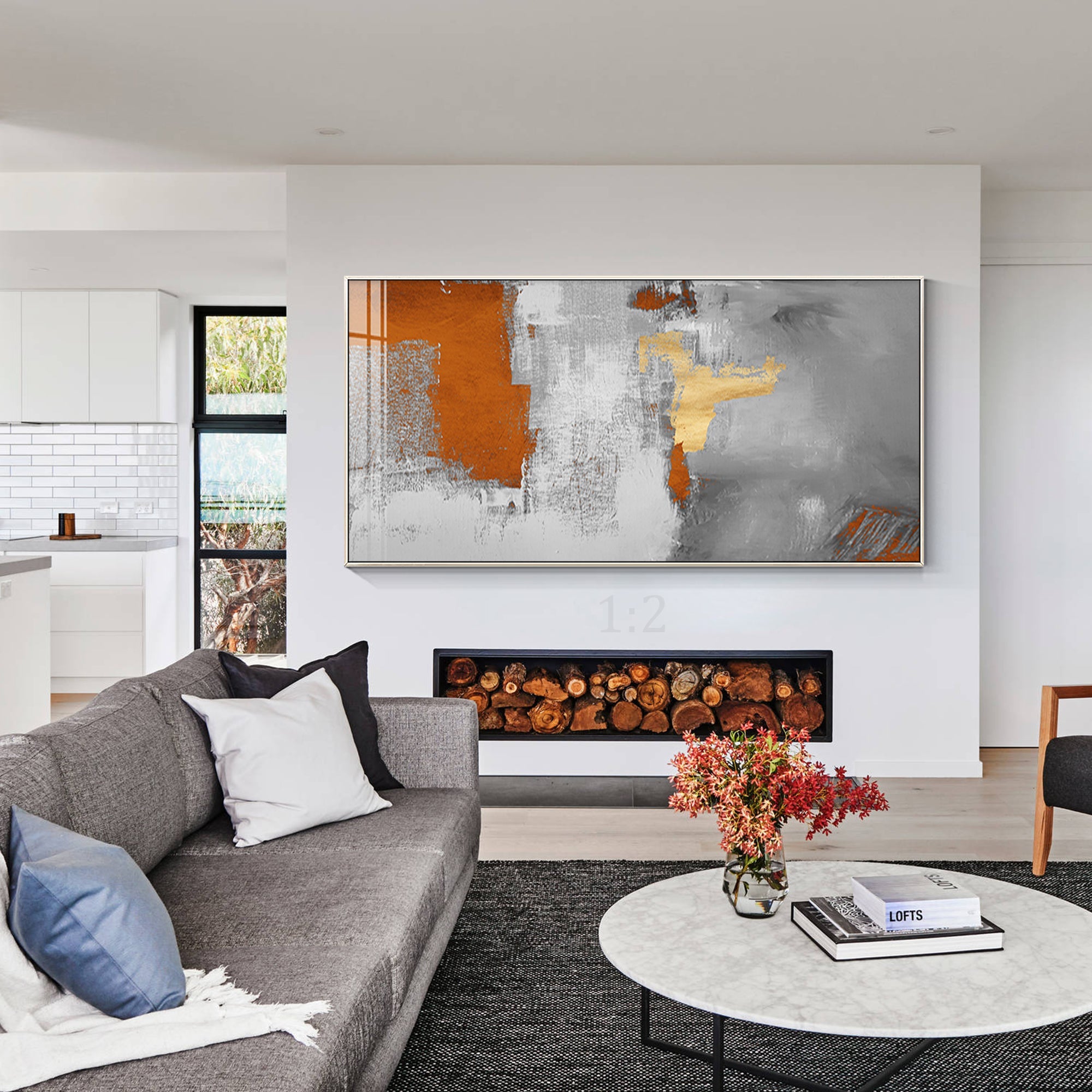 Dynamic brushstrokes in gray, white, orange, and gold creating texture and contrast decor the living room with warm color tone.
