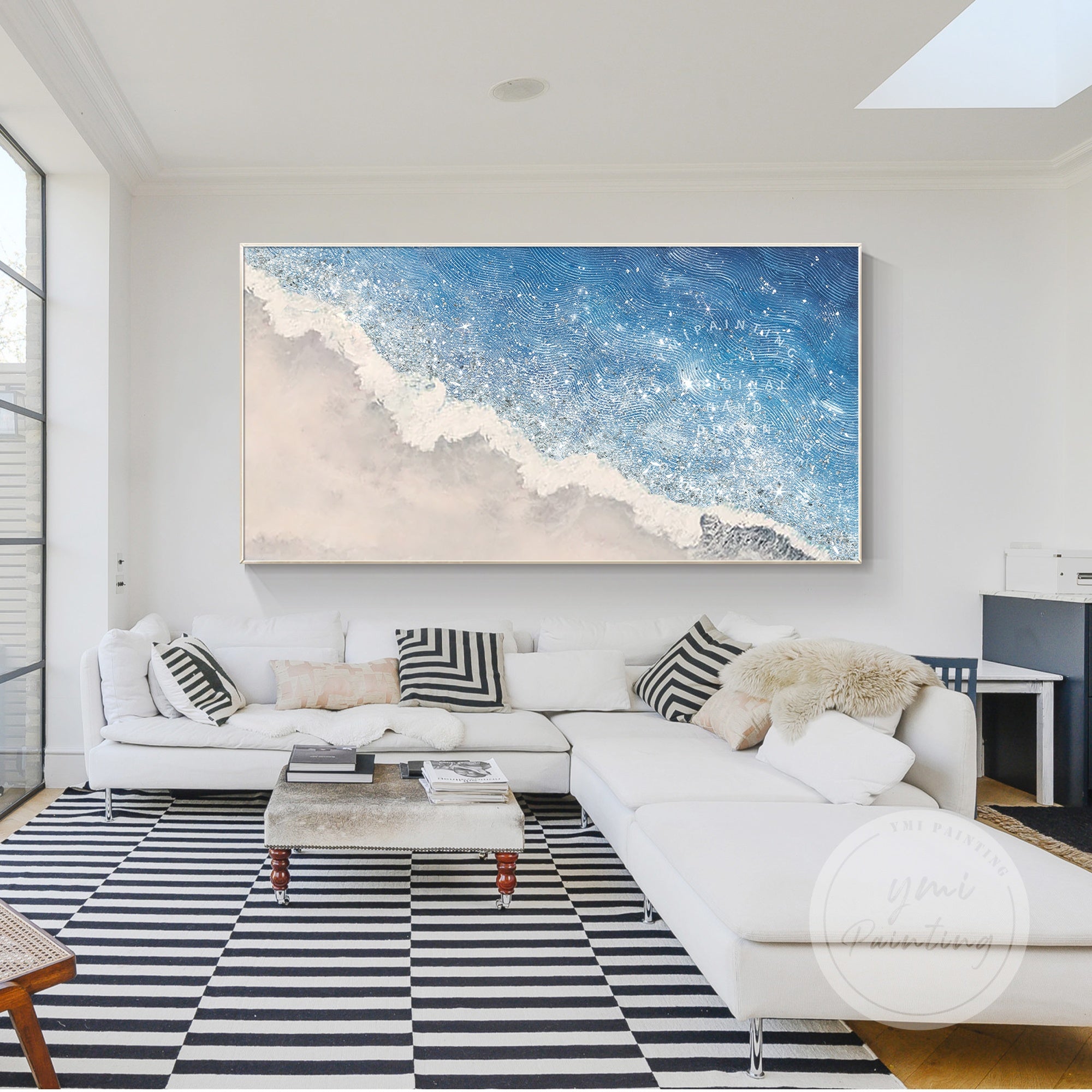 A peaceful seaside painting with white sand, textured waves, and soft blue tones, adding calmness to bedroom decor.