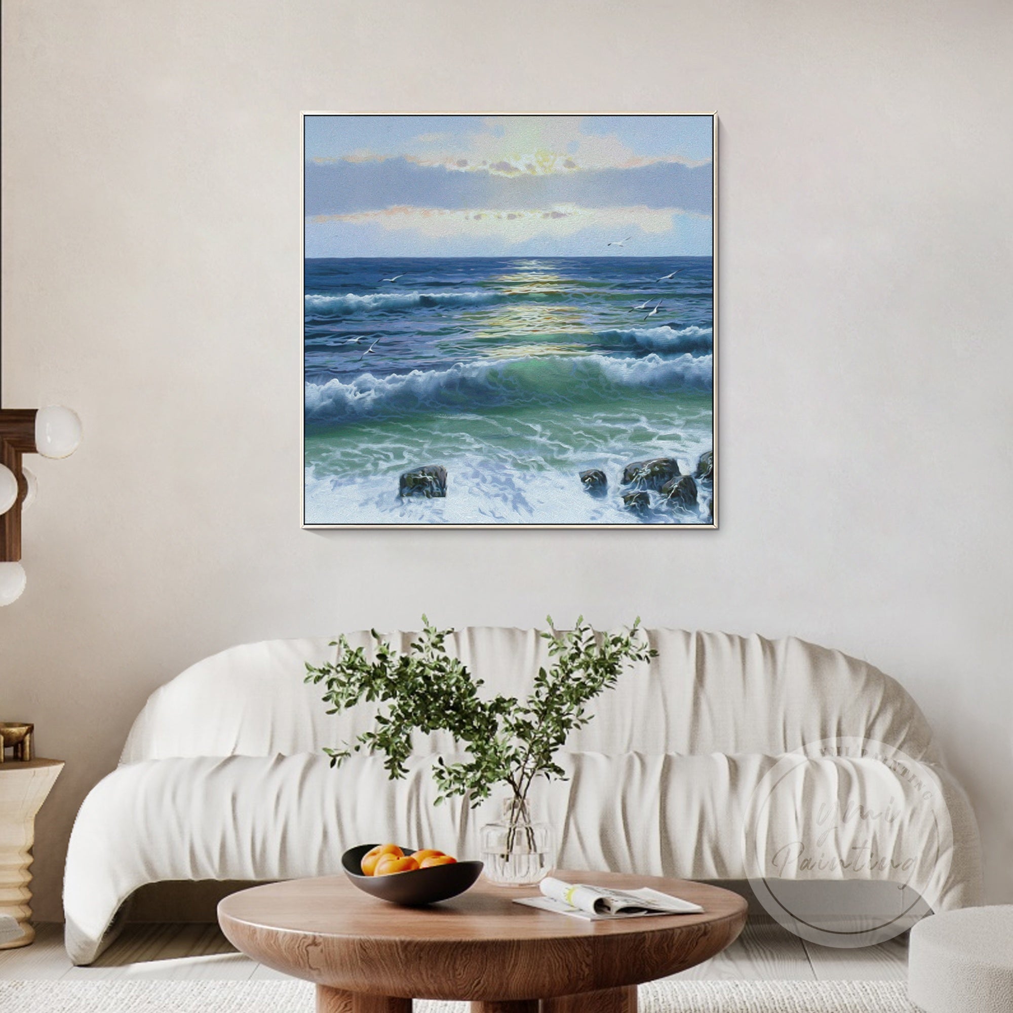 Large framed seascape painting featuring golden sunset hues over a dynamic ocean scene.