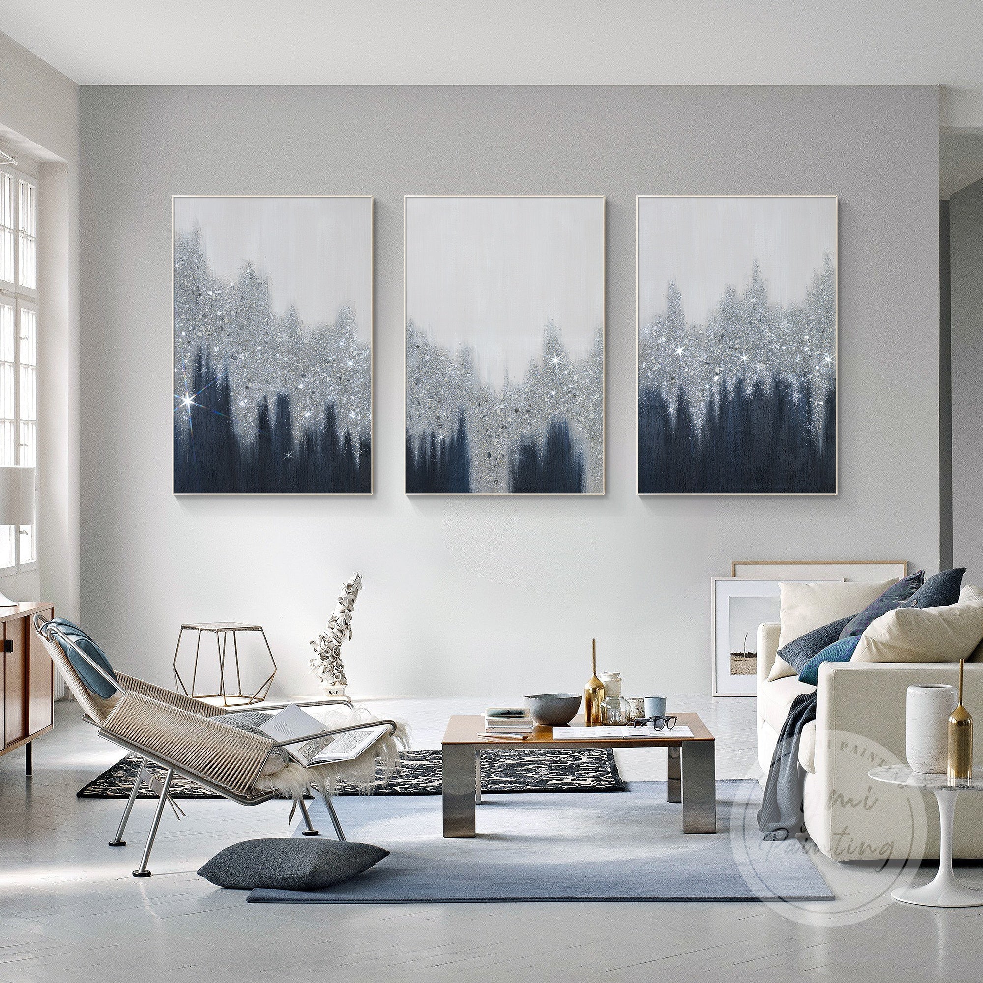 Abstract set of 3 with navy ombre, silver glitter accents, and light grey tones add elegance to a contemporary living room.