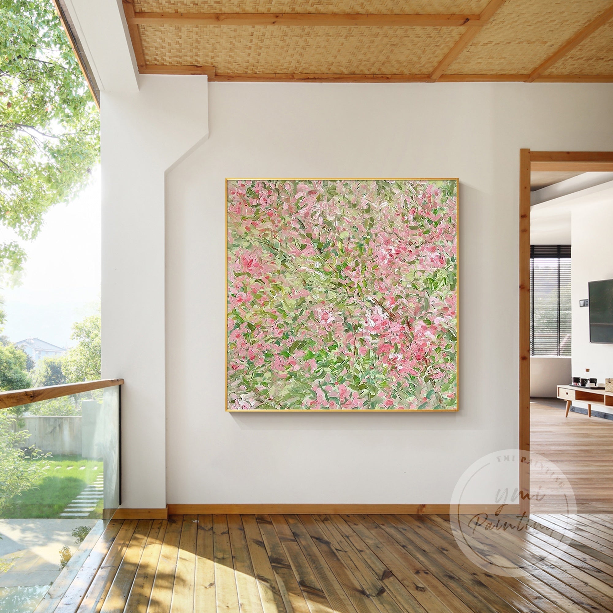 Elegant square canvas art featuring pink flowers swaying gently against a crisp white background of the modern living room.
