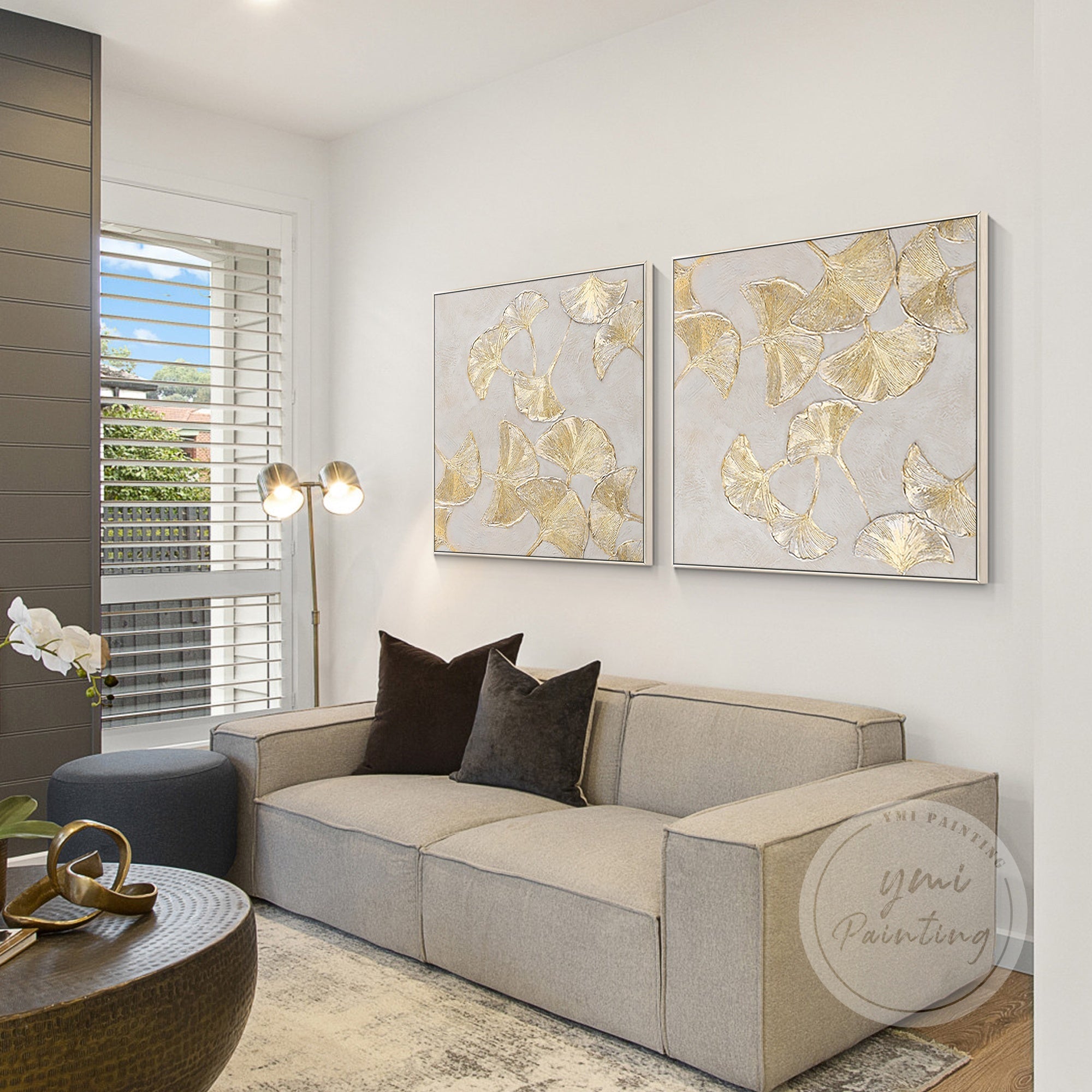 Large framed gold ginkgo biloba leaf paintings, creating a harmonious and nature-inspired atmosphere.