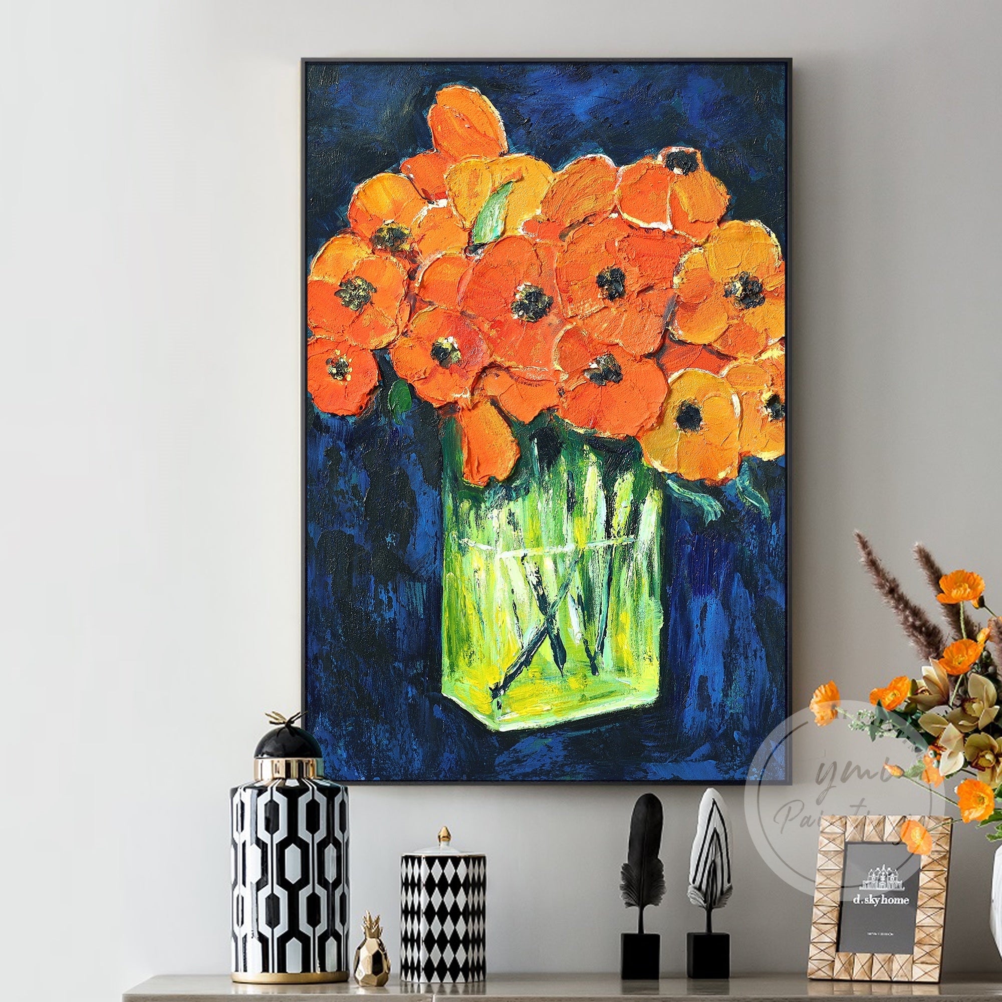 This vibrant painting of orange flowers against a deep blue backdrop brings a striking and bold touch to any room, perfect for adding energy and style.
