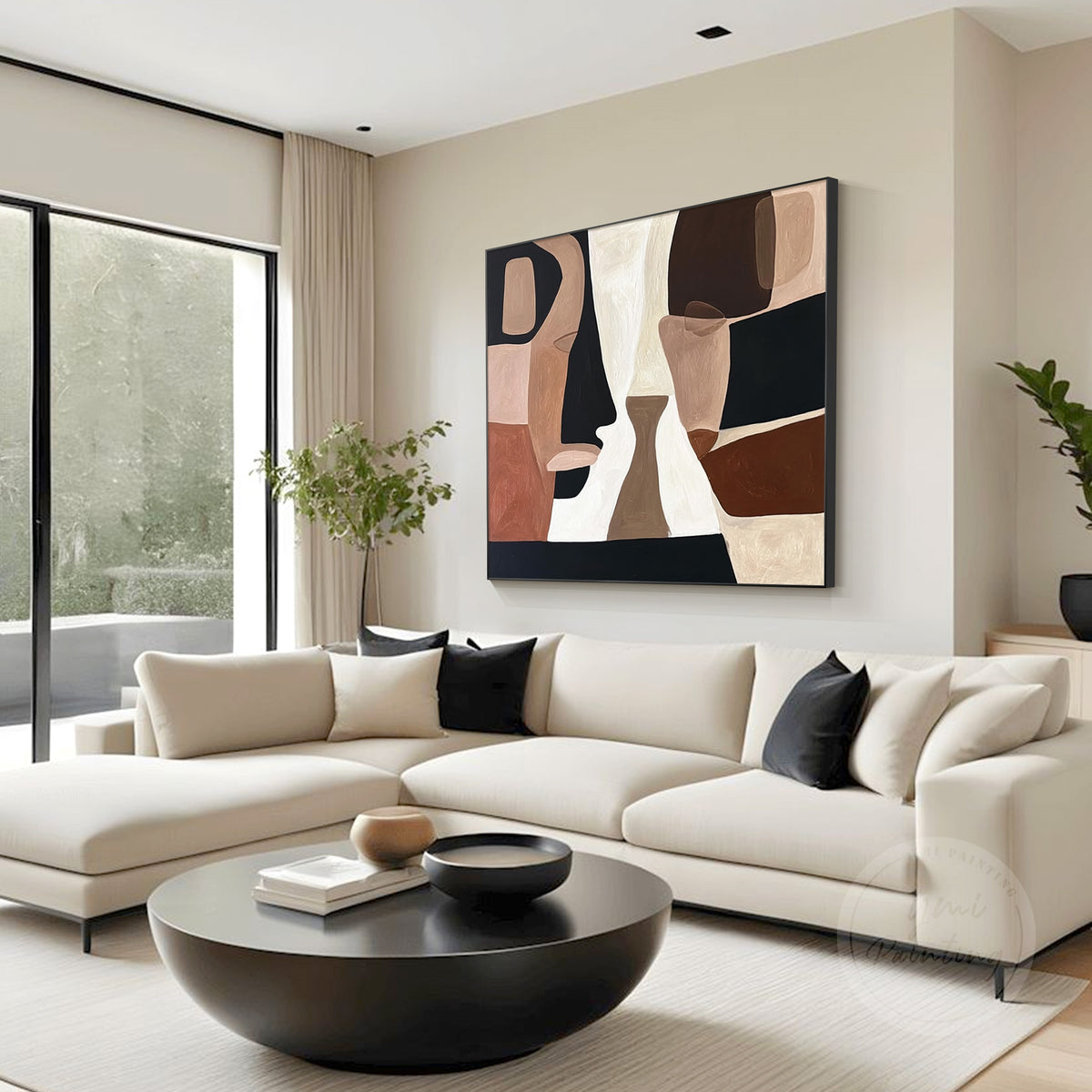 Abstract face wall art hanging above a sofa in a modern living room
