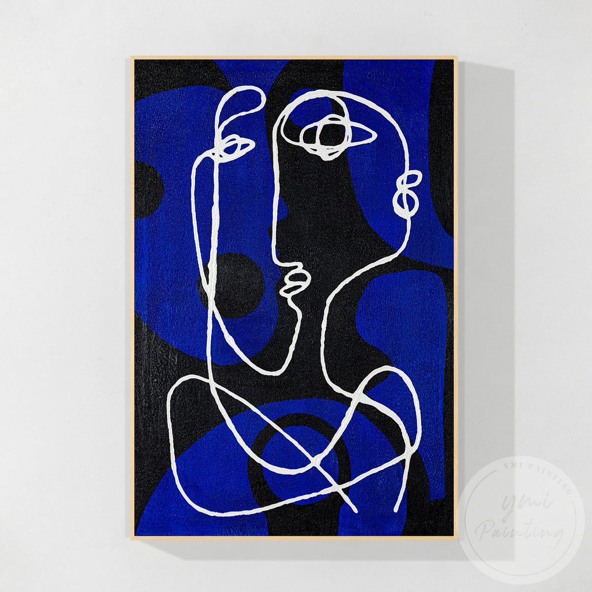 Textured blue abstract canvas artwork above a modern sofa