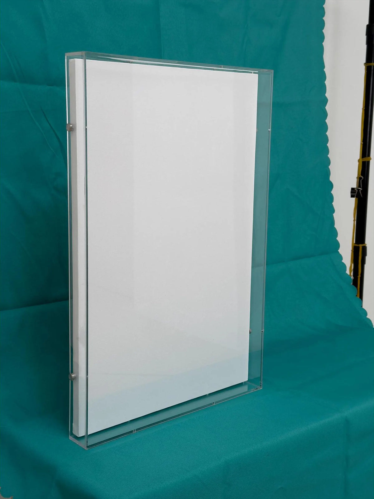 Blank stretched canvas inside a clear acrylic frame box