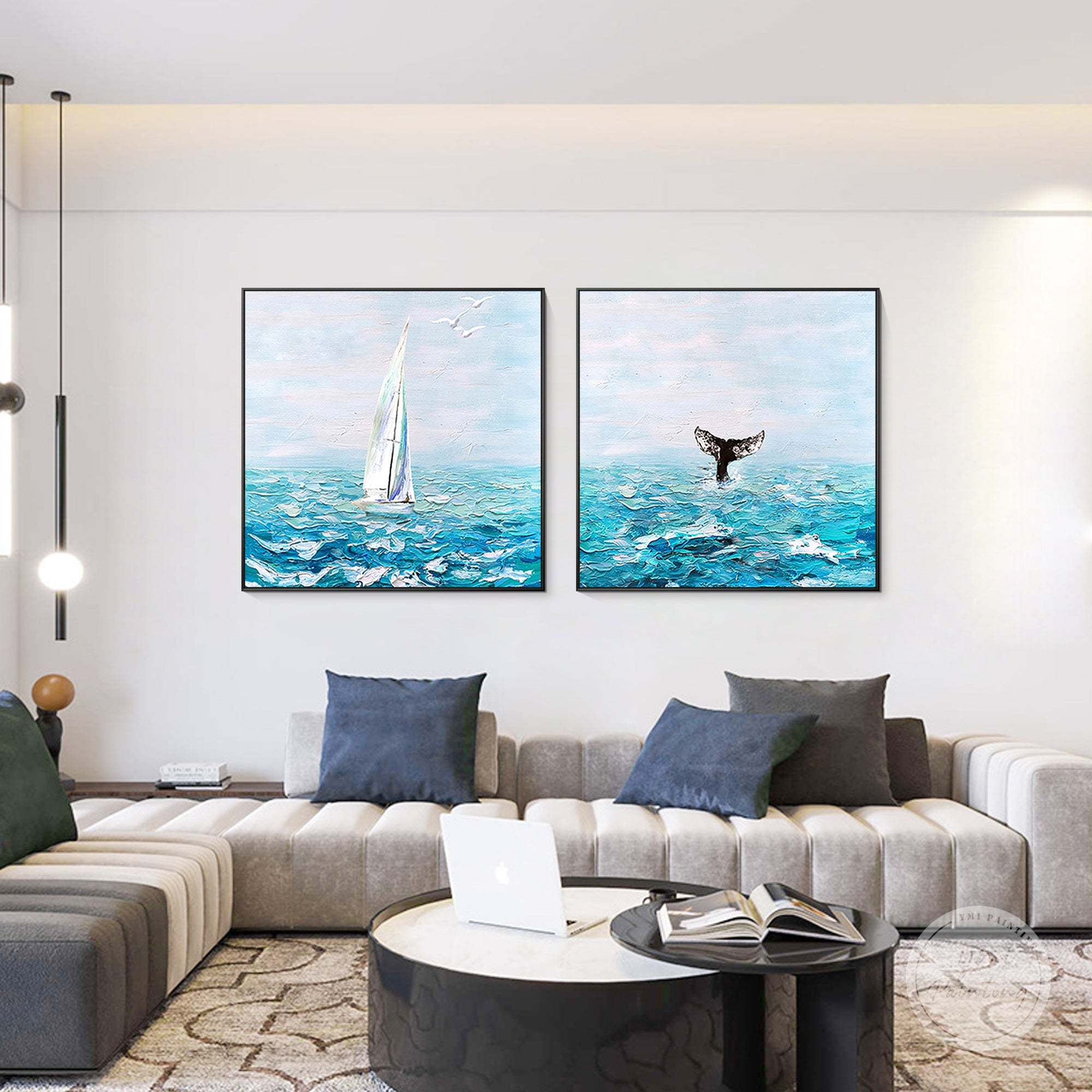 Abstract blue ocean sailboat and whale tail wall art in bright living room interior