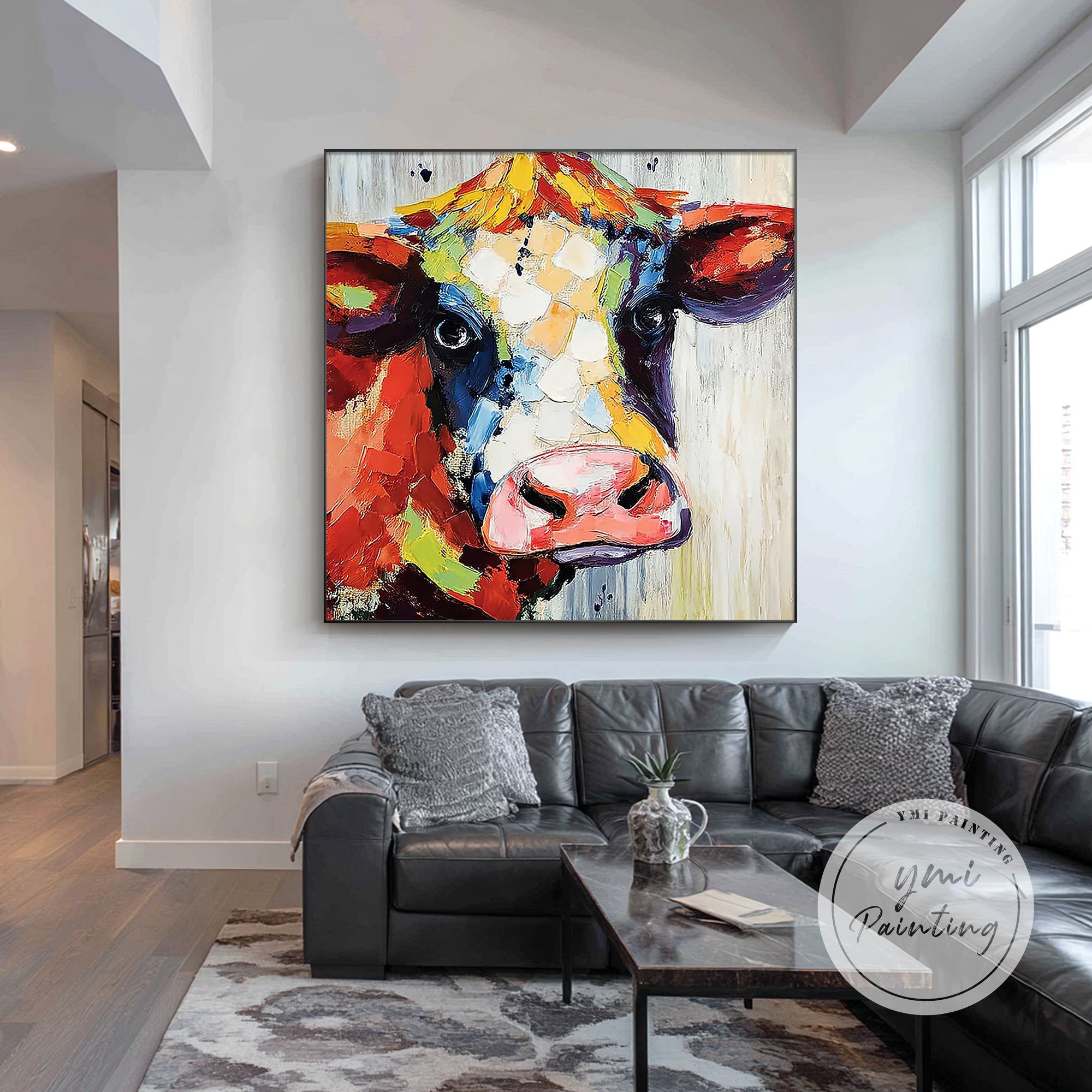 Modern farmhouse cow canvas wall art hanging in a stylish living room.
