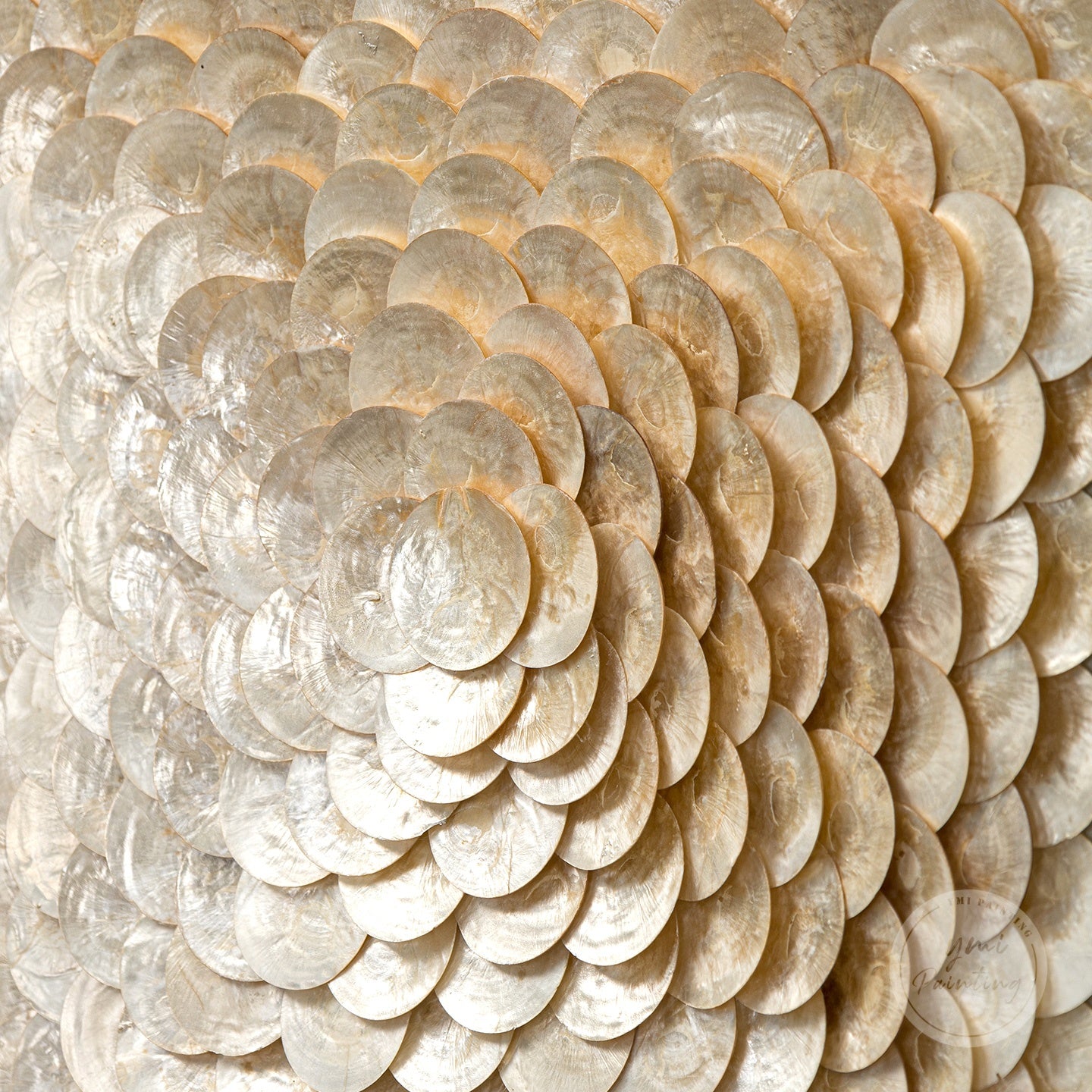 Large shell art with gold accents, adding a luxurious coastal touch to any space.