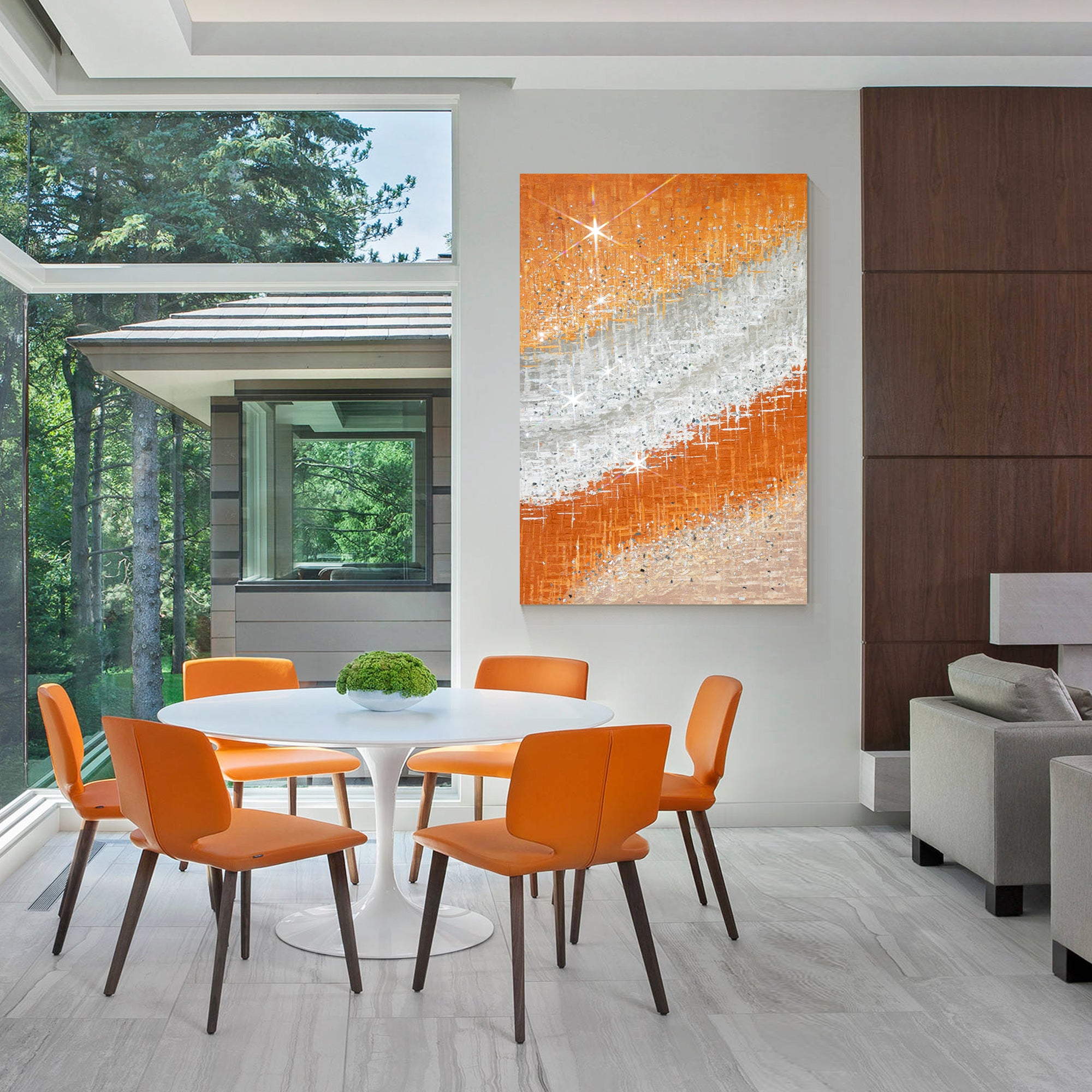 Abstract artwork featuring vibrant orange hues, crushed glass, and silver accents in a forest villa.