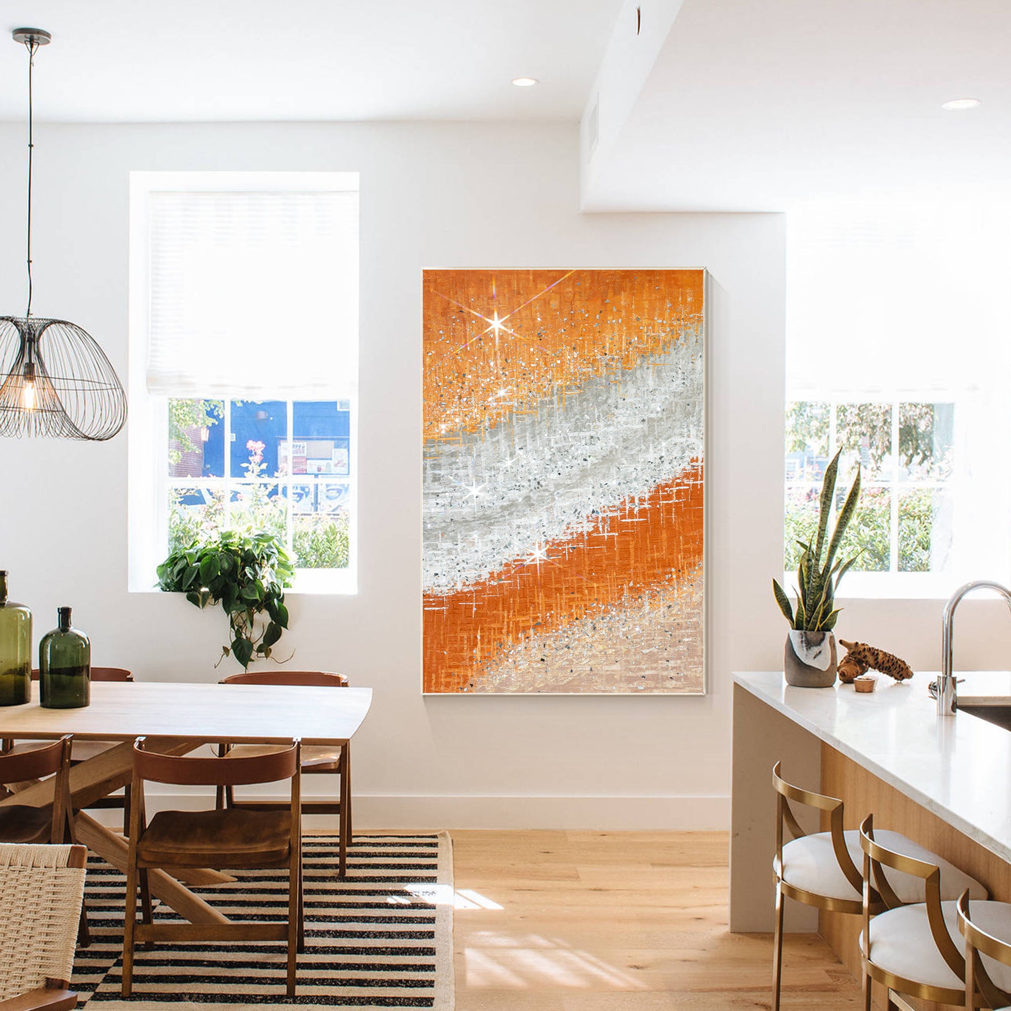 Abstract painting with vibrant orange tones, silver, and crushed glass accents in a minimalist home.