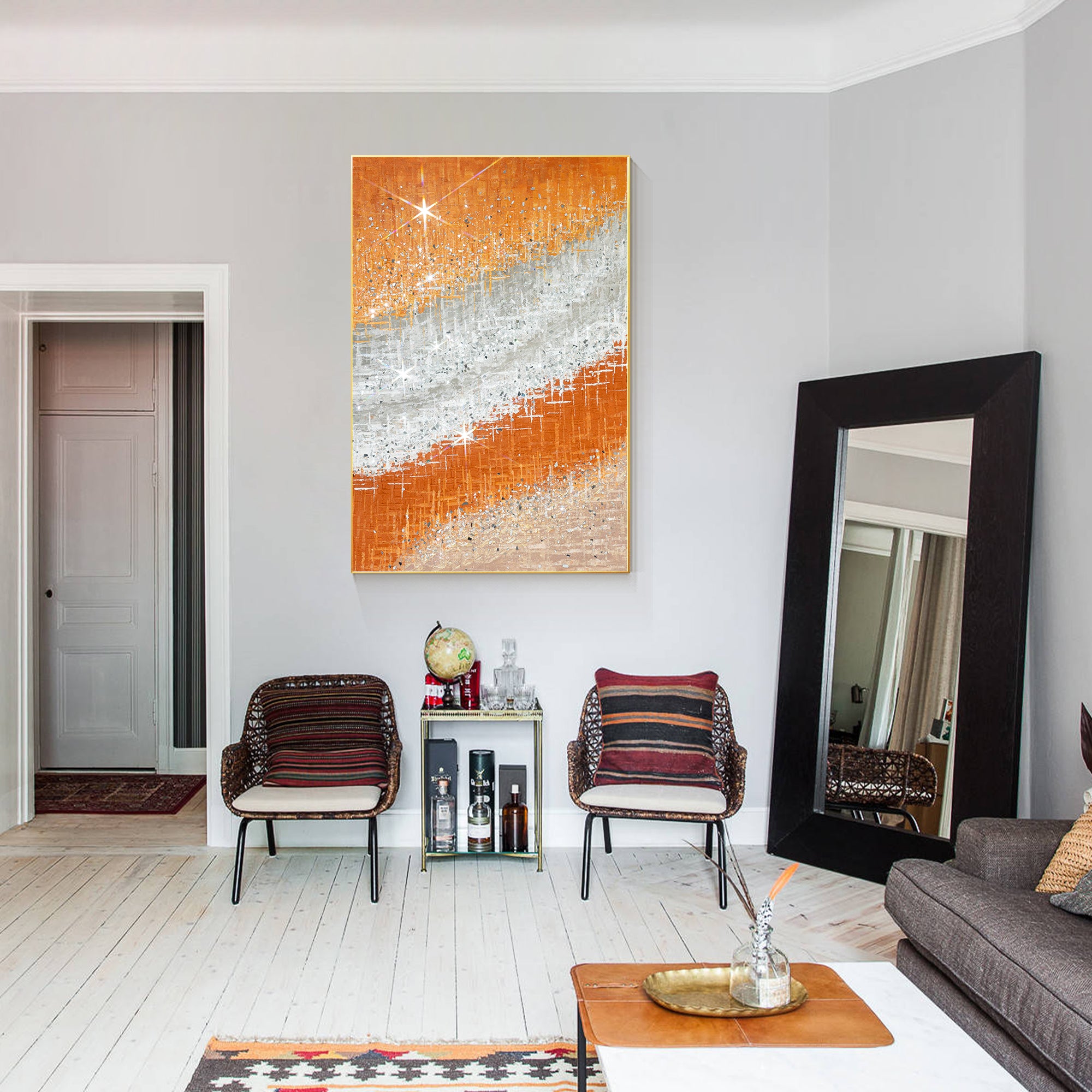 Abstract art with crushed glass texture and vibrant orange tones balanced by silver and white decoring an American style home.