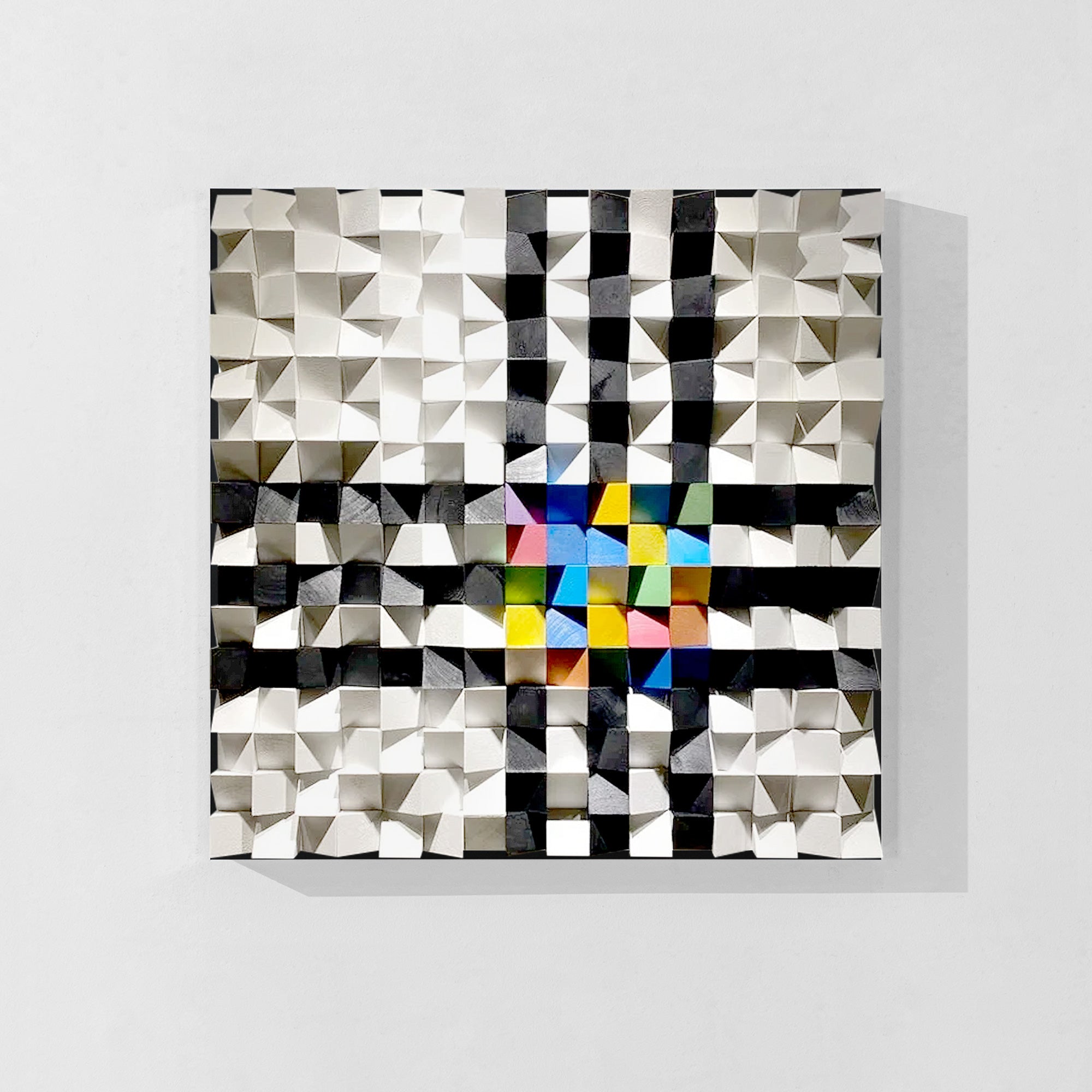 Geometric artwork with a black and white wood background and colorful triangles at the center of each layer.