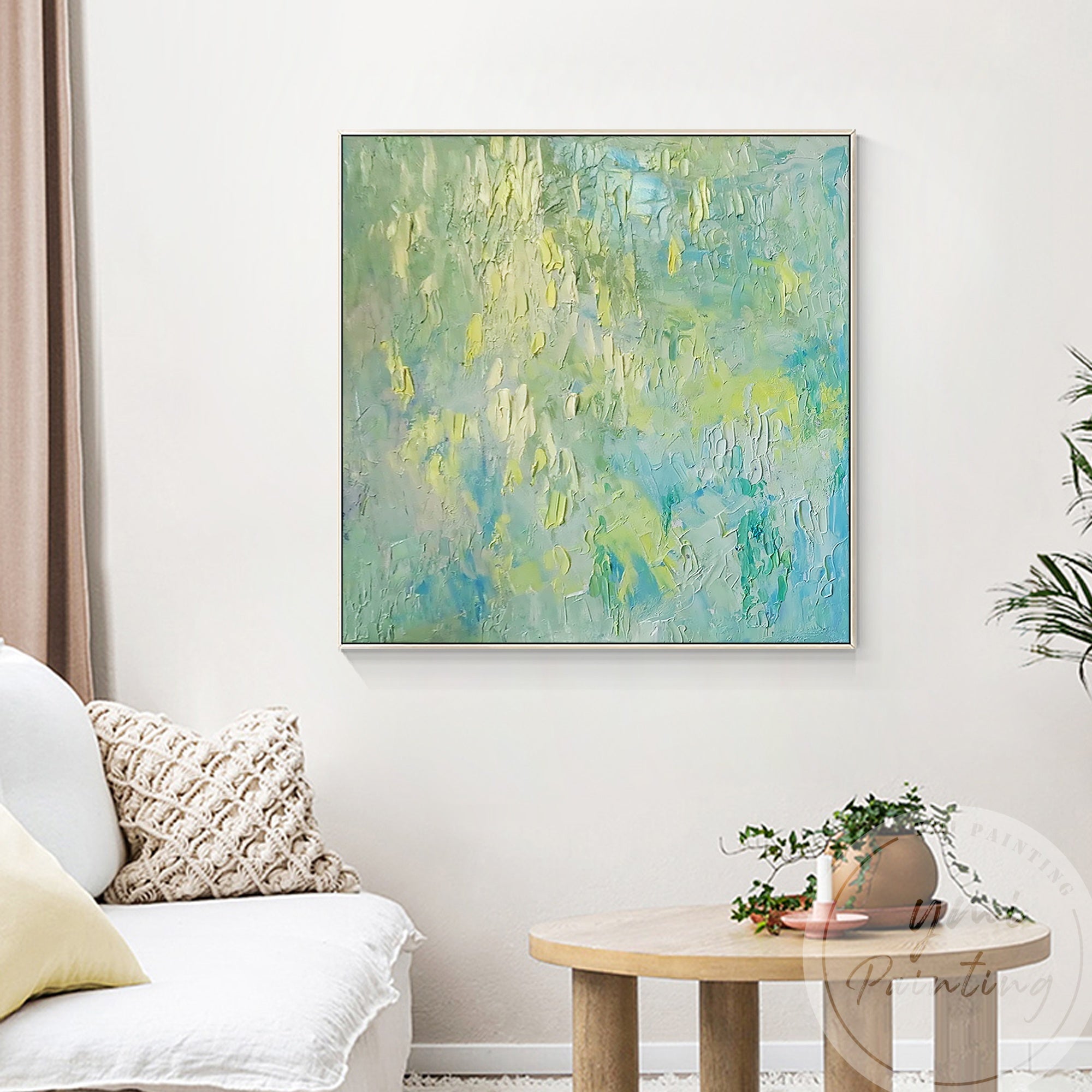 Textured brushstrokes and pale yellow highlights add depth and calm to this cozy living room decor.