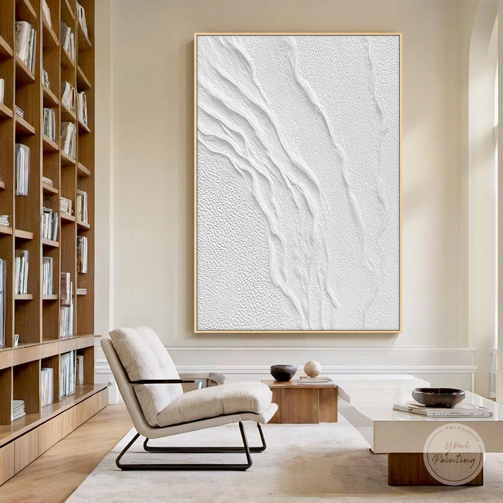 Handmade monochrome textured artwork hanging beside a staircase in a modern home