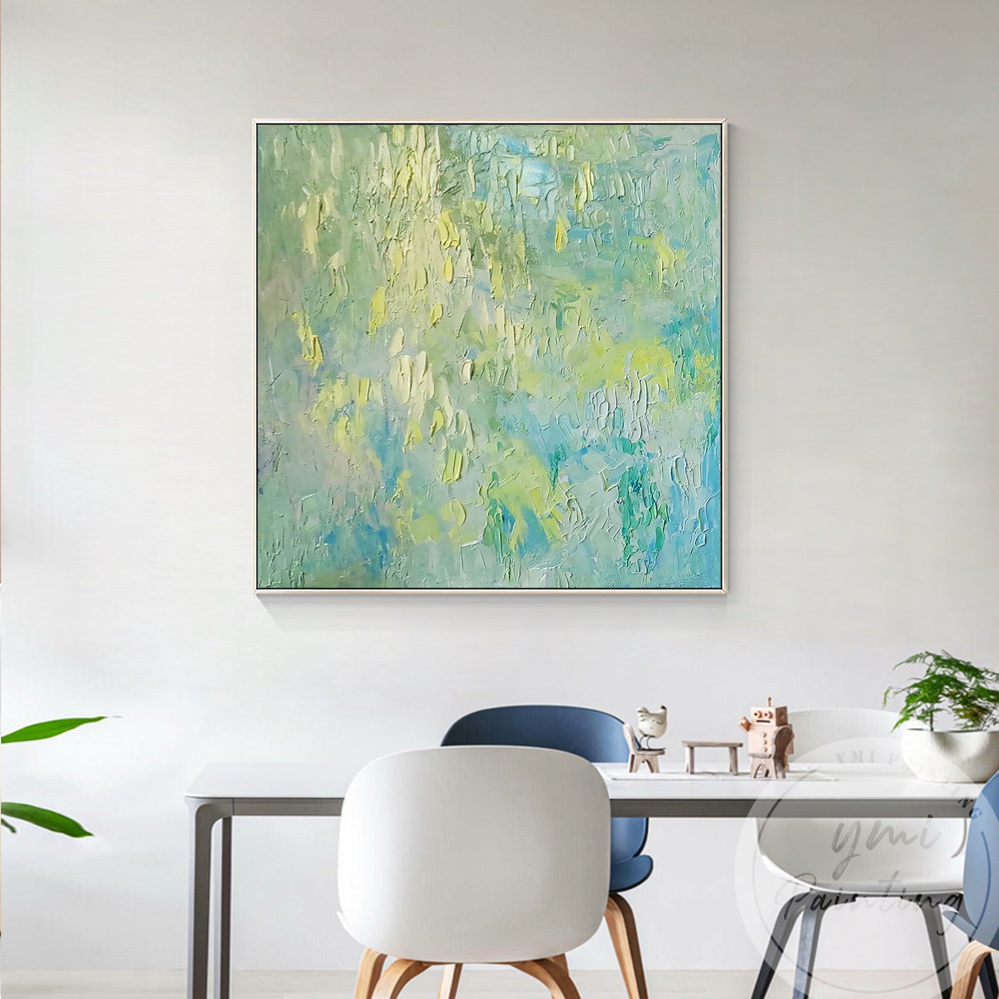 Soft pastel greens, blues, and textured brushstrokes create a tranquil atmosphere in modern dining decor.