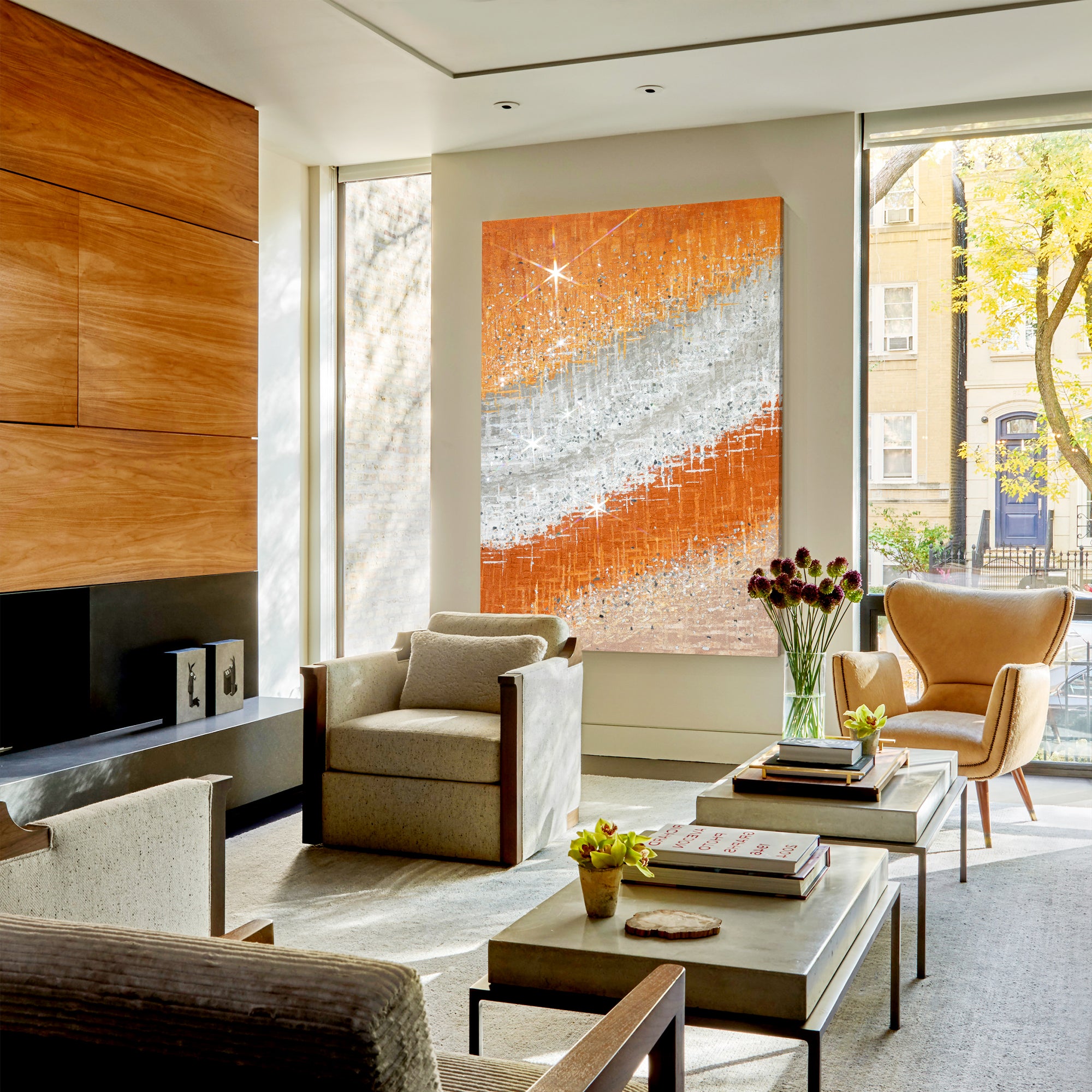 Shimmering abstract painting with orange, silver, and crushed glass elements in a modern style apartment.