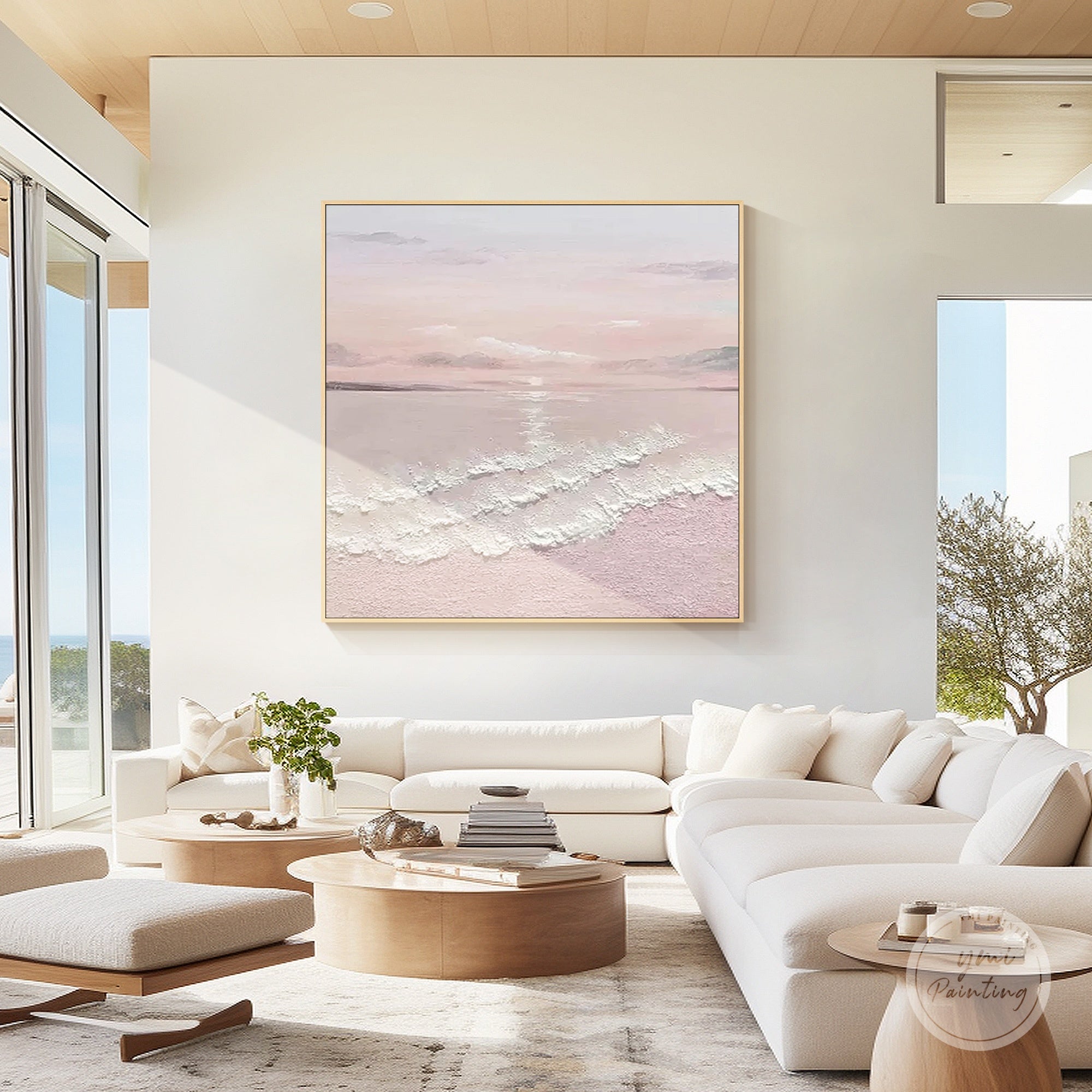 Pastel pink ocean oil painting with textured waves styled above a sofa in a contemporary living room