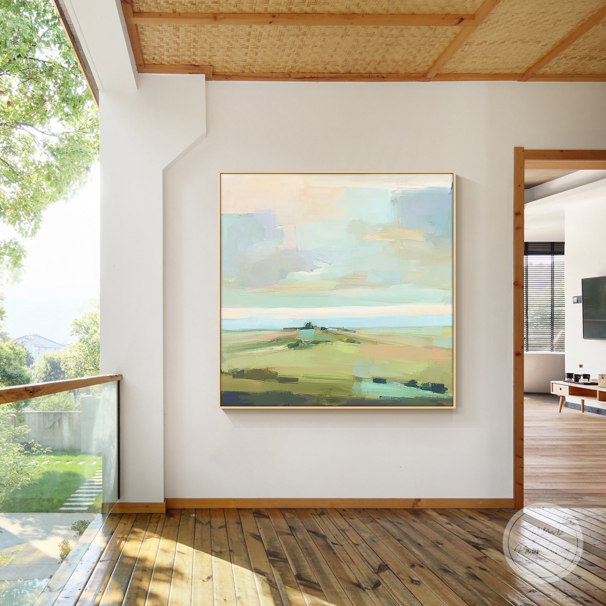 Soft pastel abstract landscape painting on square canvas mounted on a neutral wall