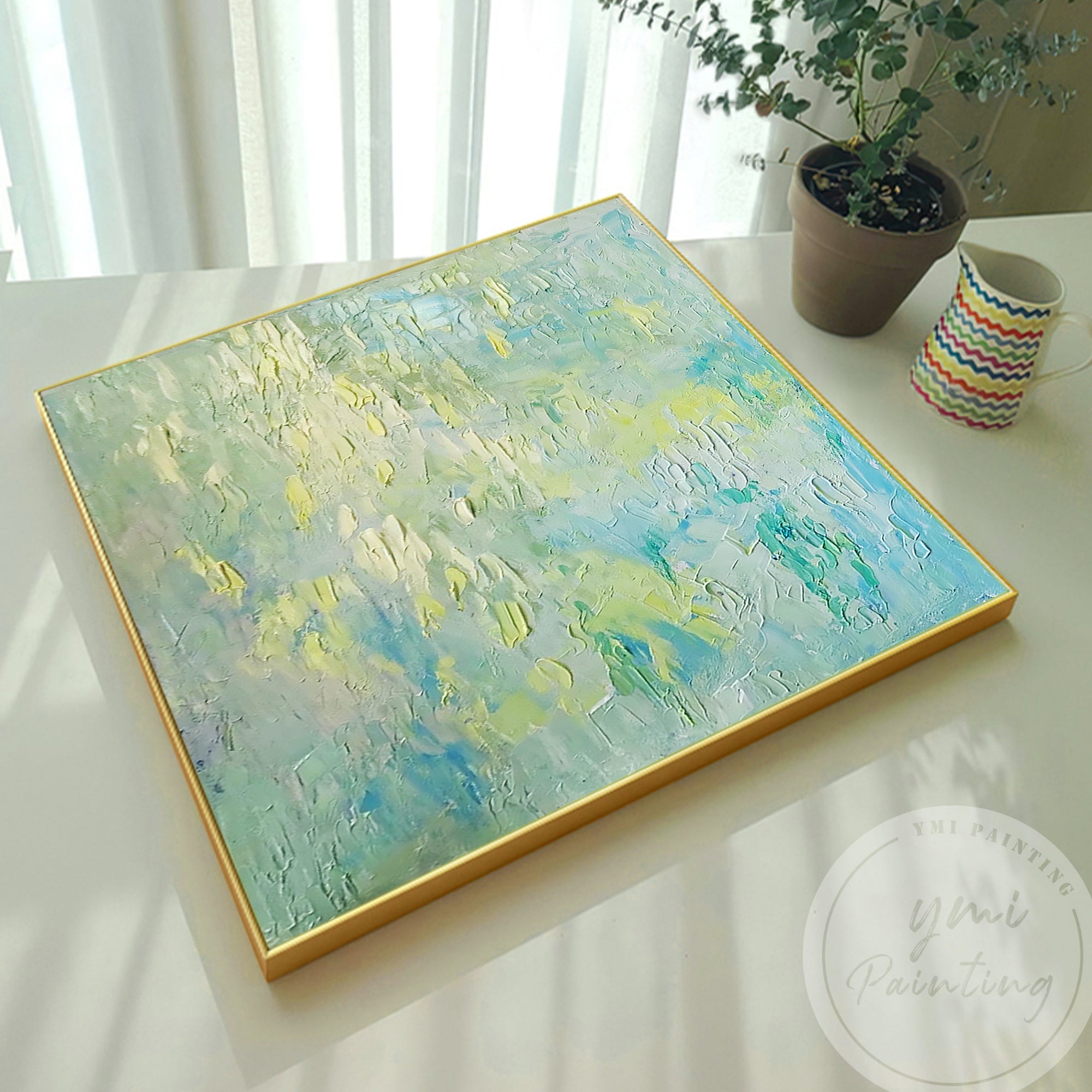 This green and blue textured artwork adds a serene, modern touch to warm living spaces.