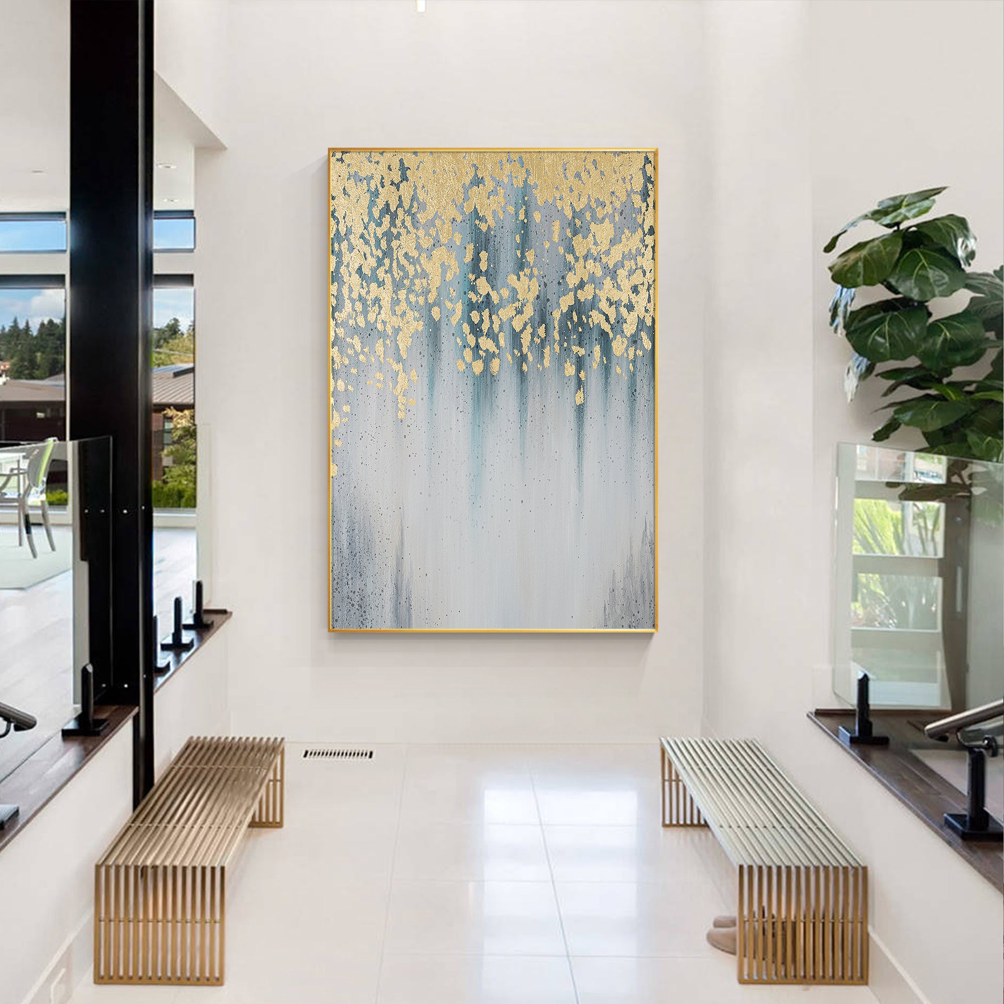 Abstract artwork with delicate gold leaf accents and water droplets falling through blue-gray tones in a modern style lobby.