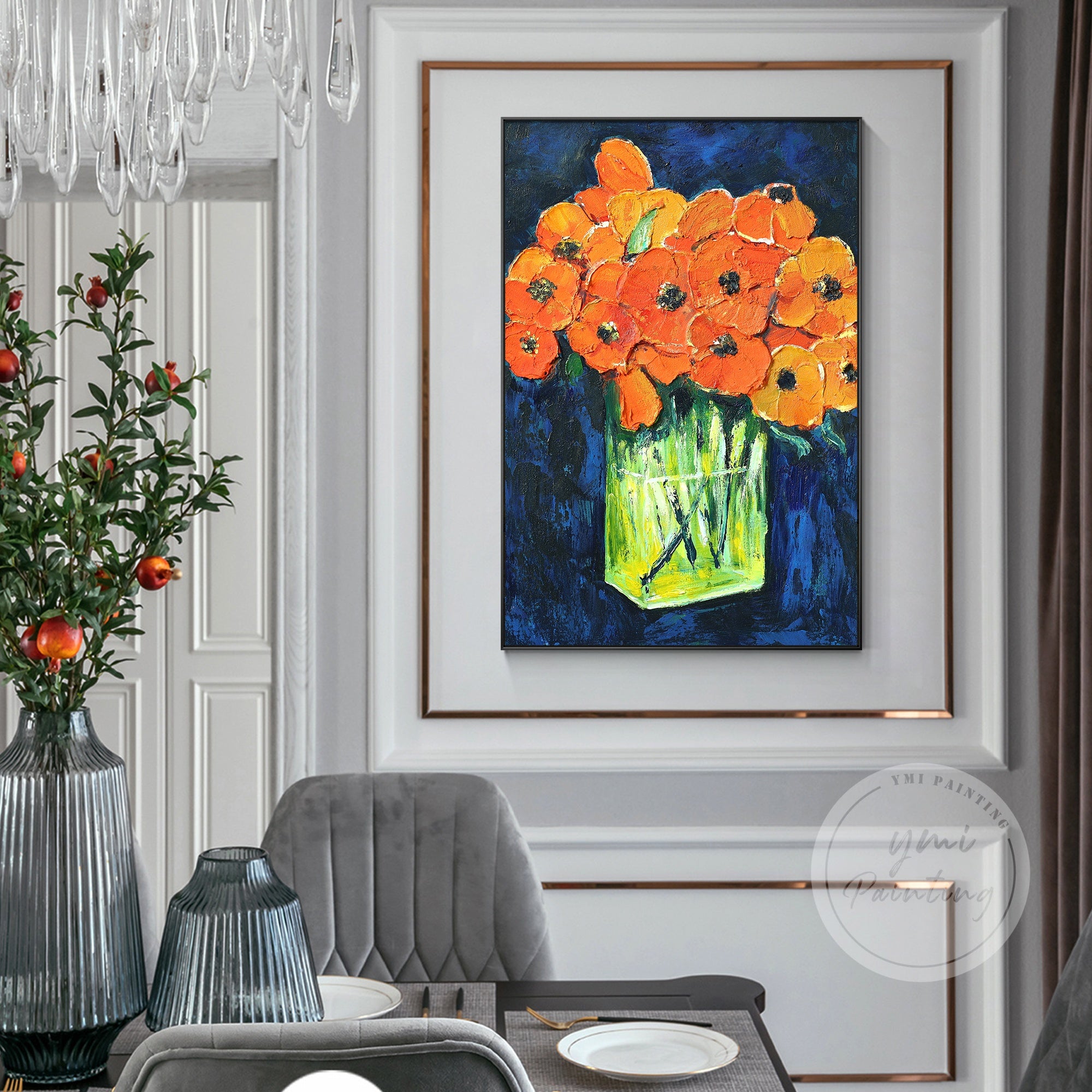 Vibrant orange flowers in a glass vase against a dark blue background, with green and yellow accents.