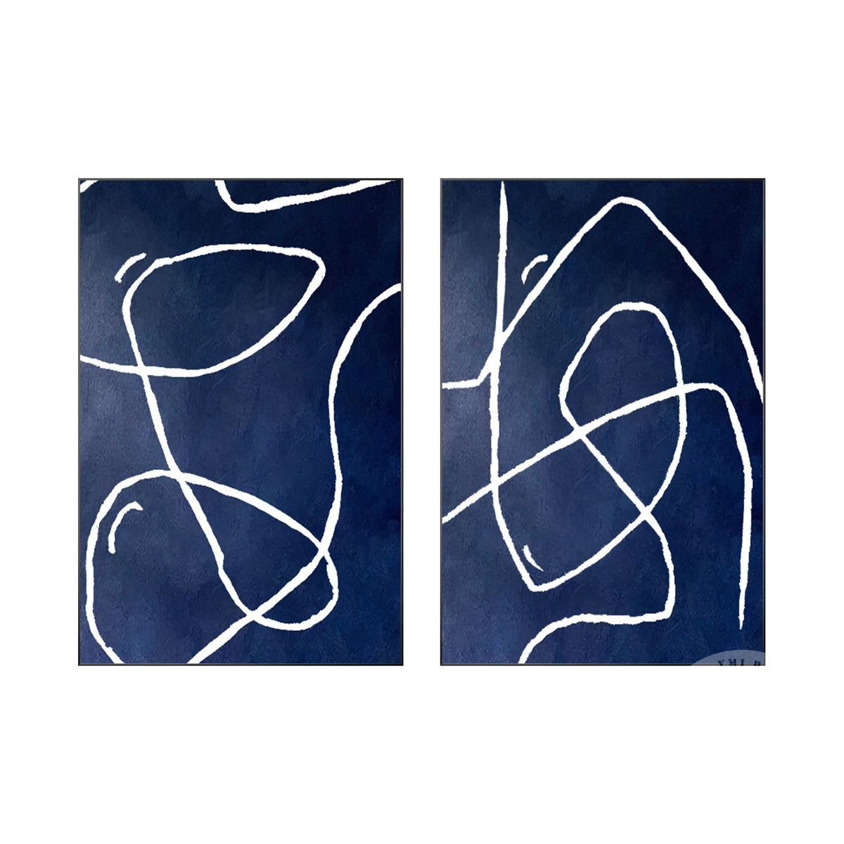 Minimalist navy blue line art diptych above a contemporary sofa