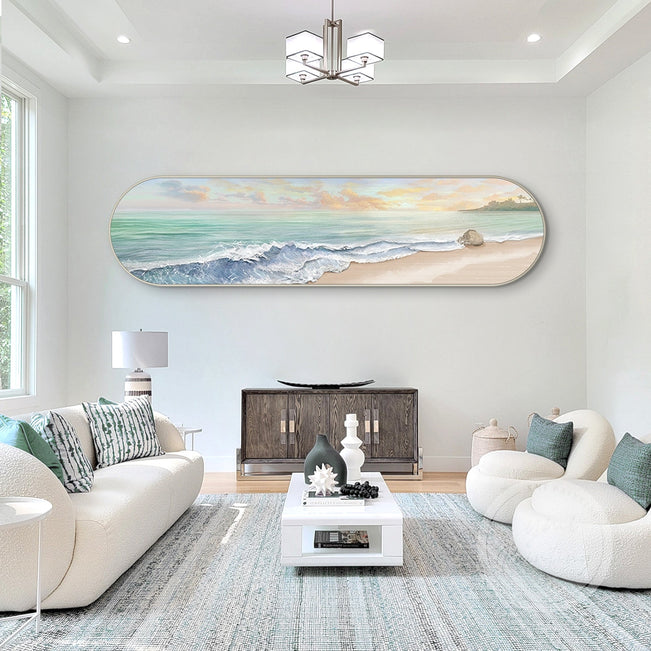 Coastal decor artwork with gentle waves and a peaceful atmosphere hang over the cozy sofa.